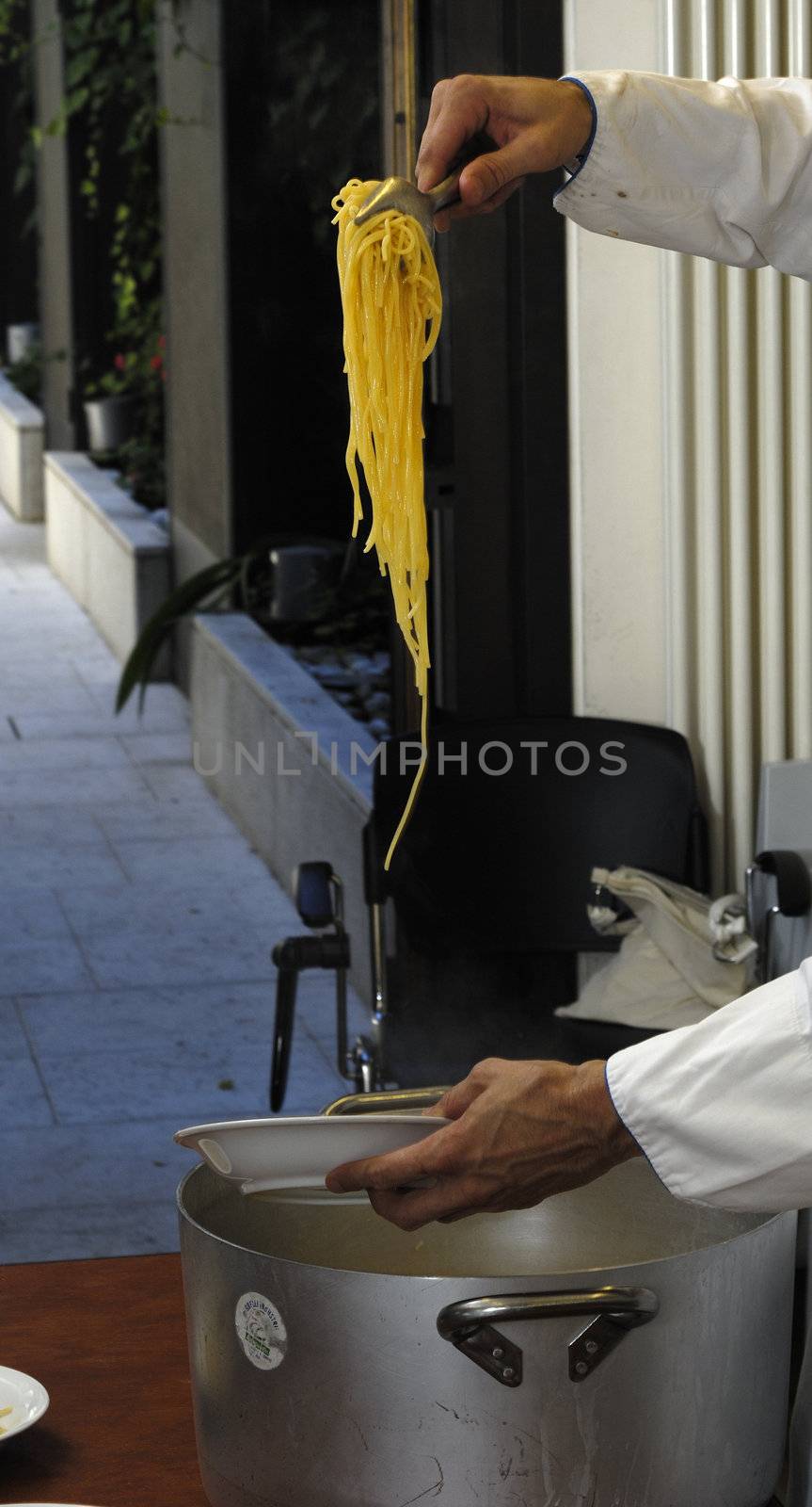 chef serving spaghetti just made