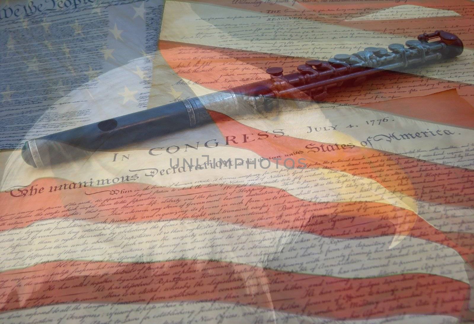 A composite of two photos taken by the author - bald eagle, American flag, Declaration of Independence and Constitution with fife combined into one photo.
