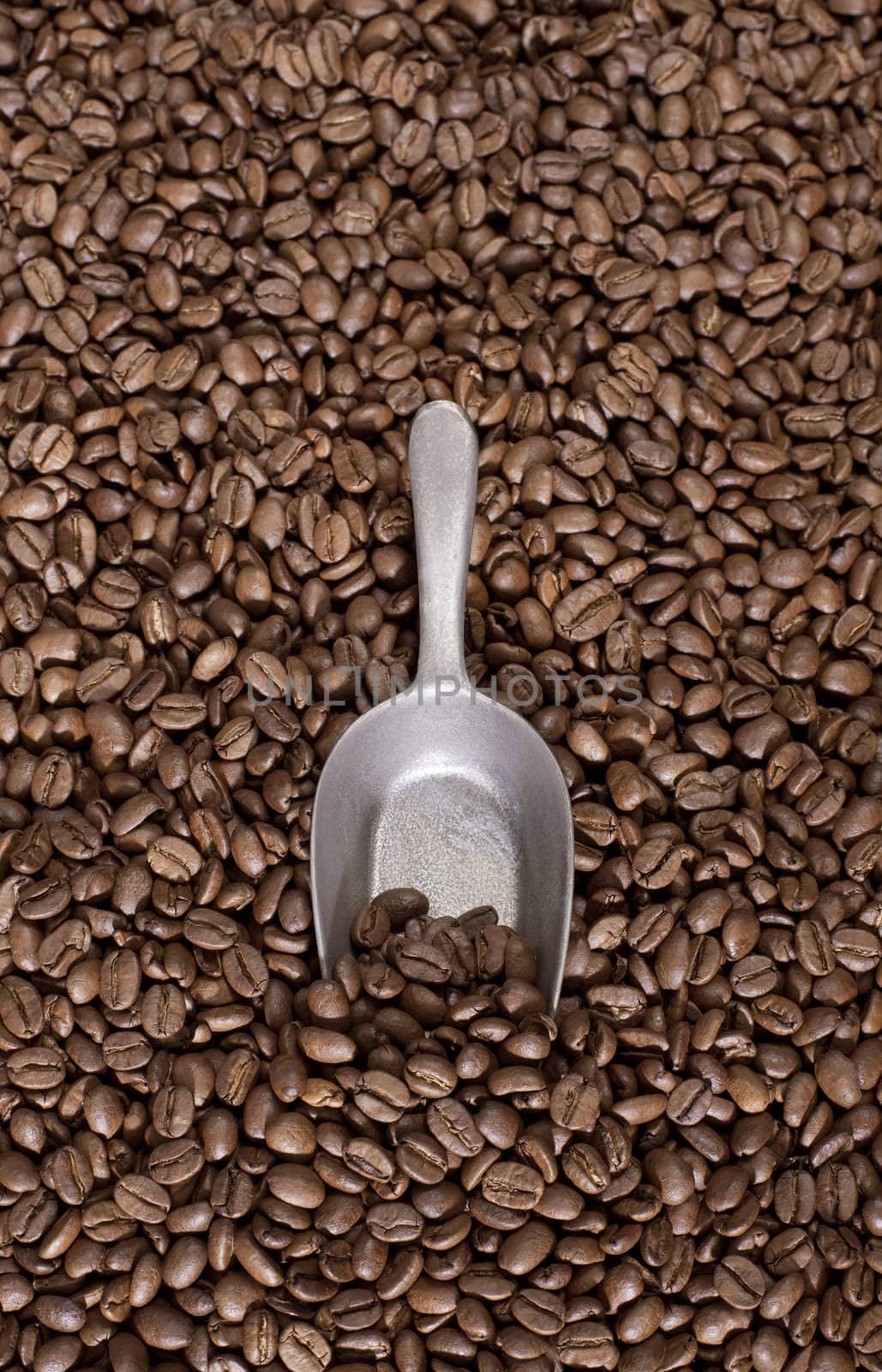 Coffee beans background with a spoon