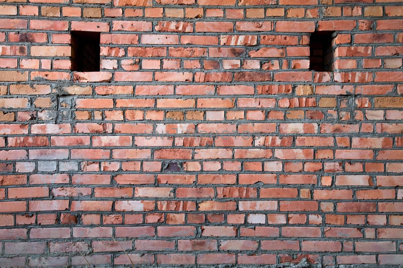 Red old brick wall structure with holes