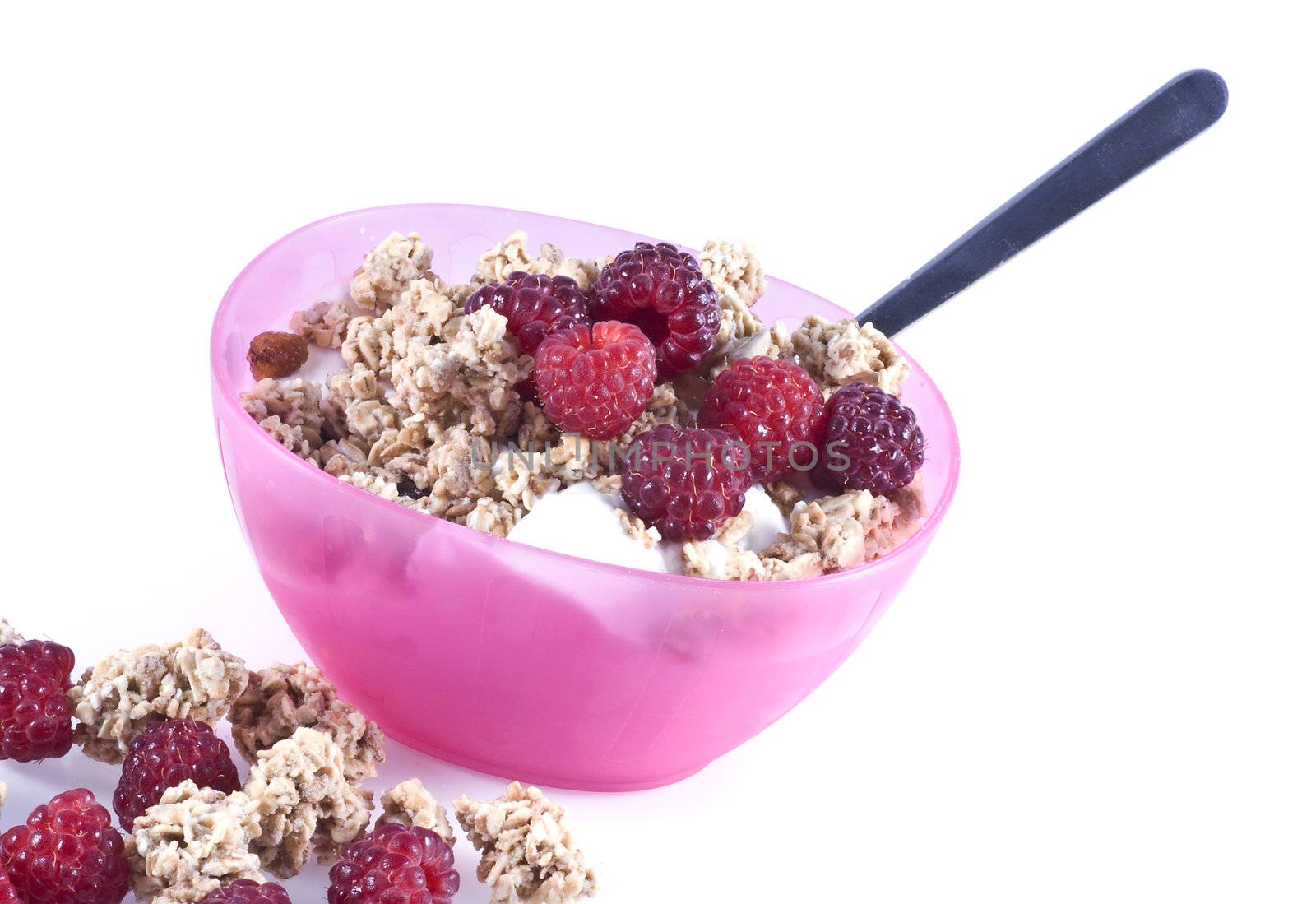 A bowl filled with curds, cereal and fresh raspberries, isolated on white.