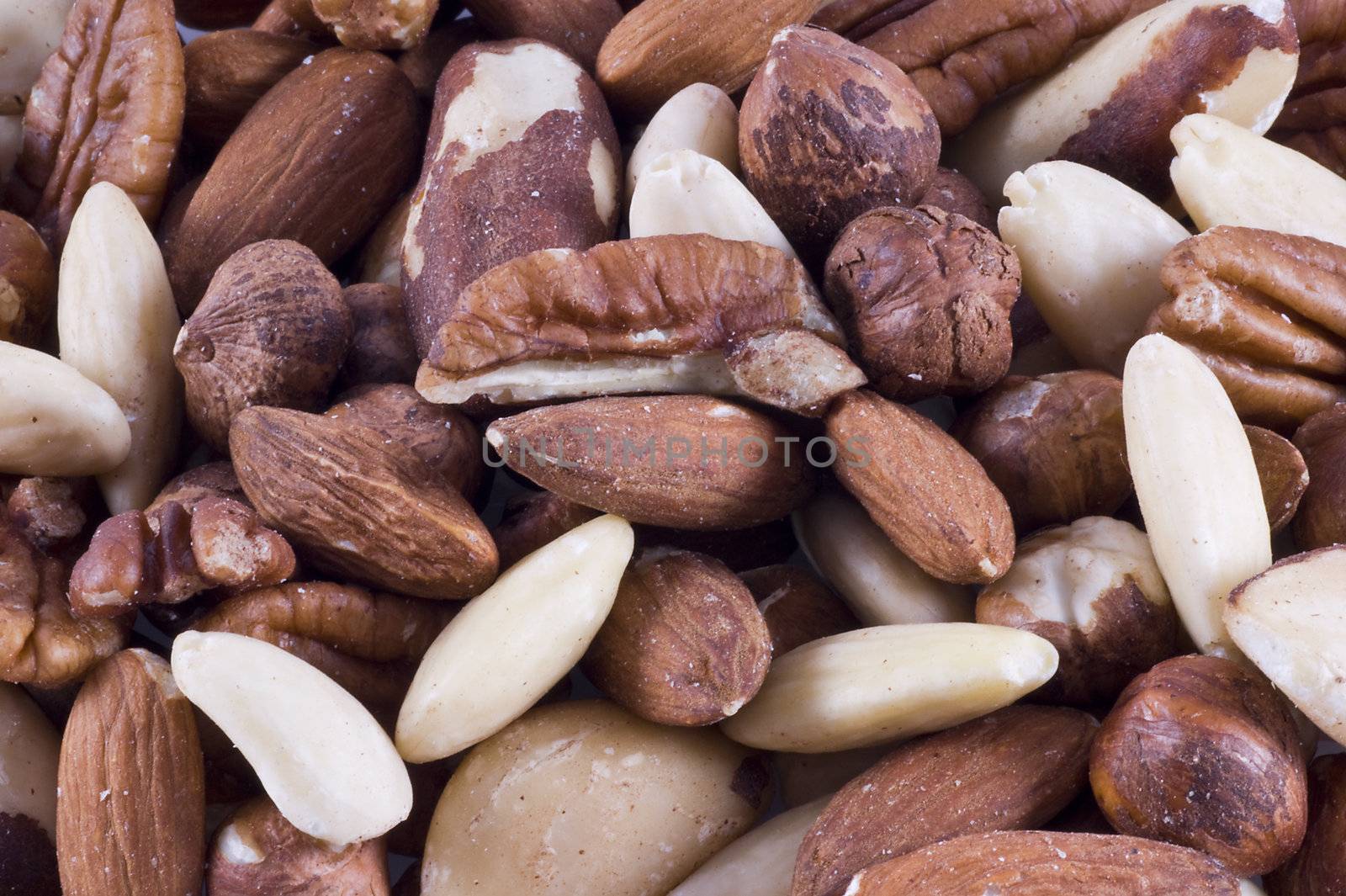 Background filled with different kinds of nuts.
