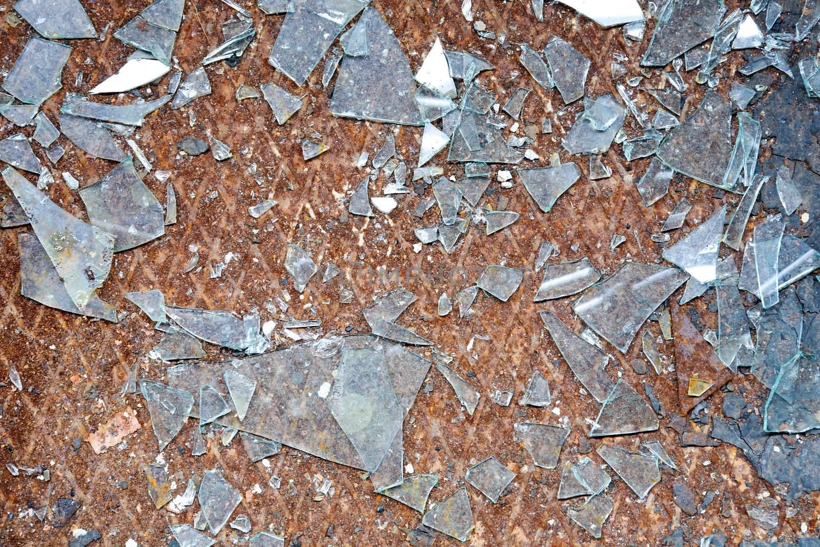 The rusty old metal floor and splinters of glass