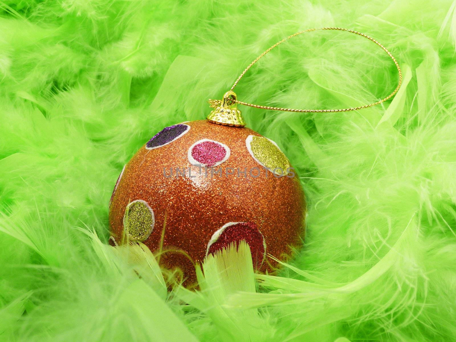 Background with green feathers and Christmas ball