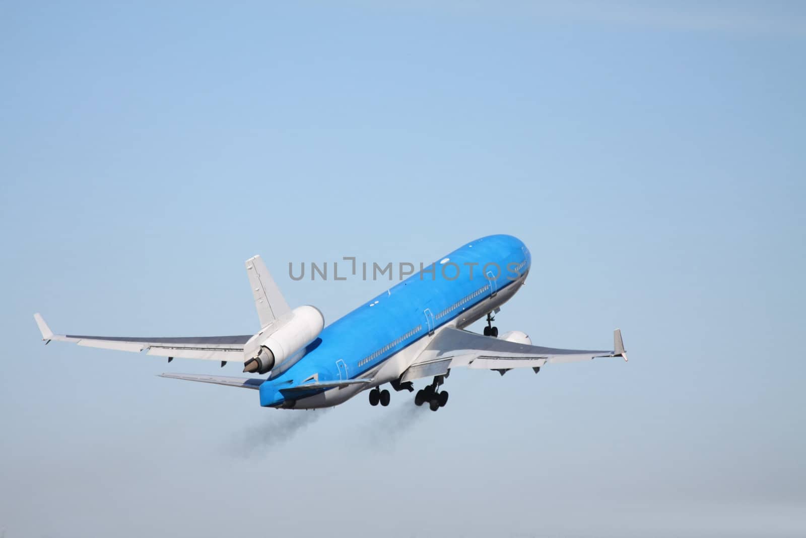 Plane in a clear blue sky by studioportosabbia