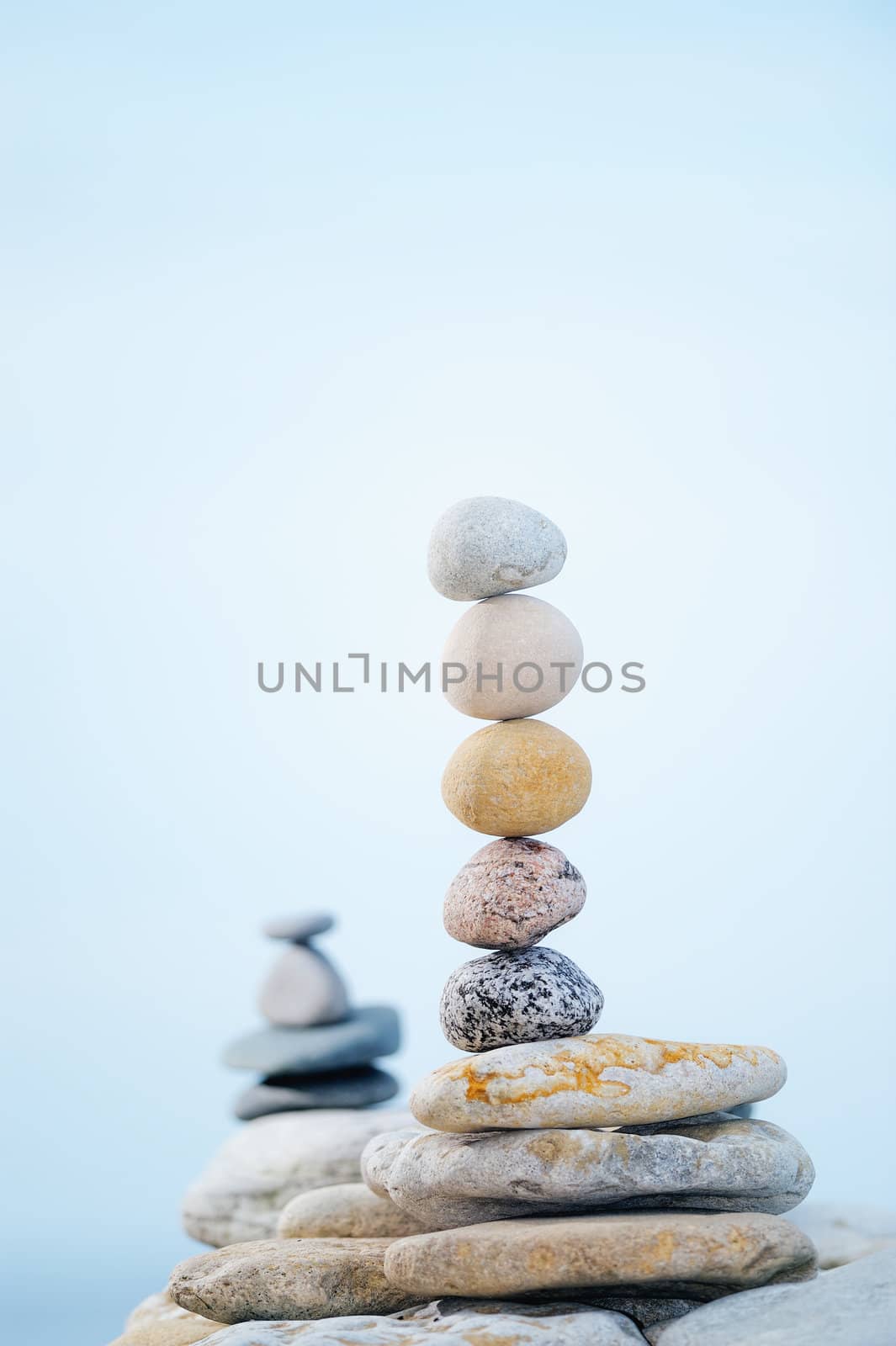 A heap of the round pebbles in the soft fog on the seashore