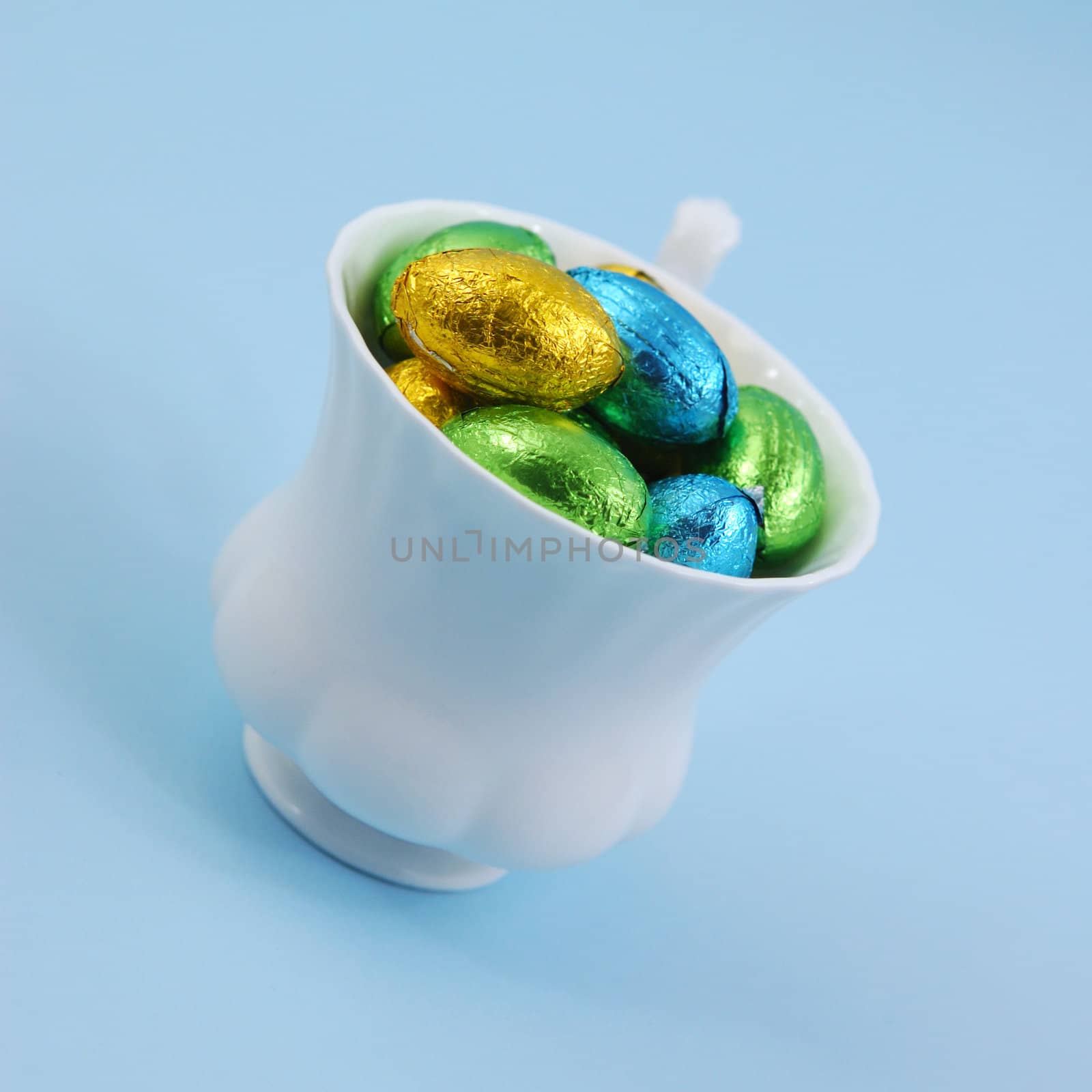 chocolate easter eggs in cup
eggs on blue background
easter eggs in white cup
