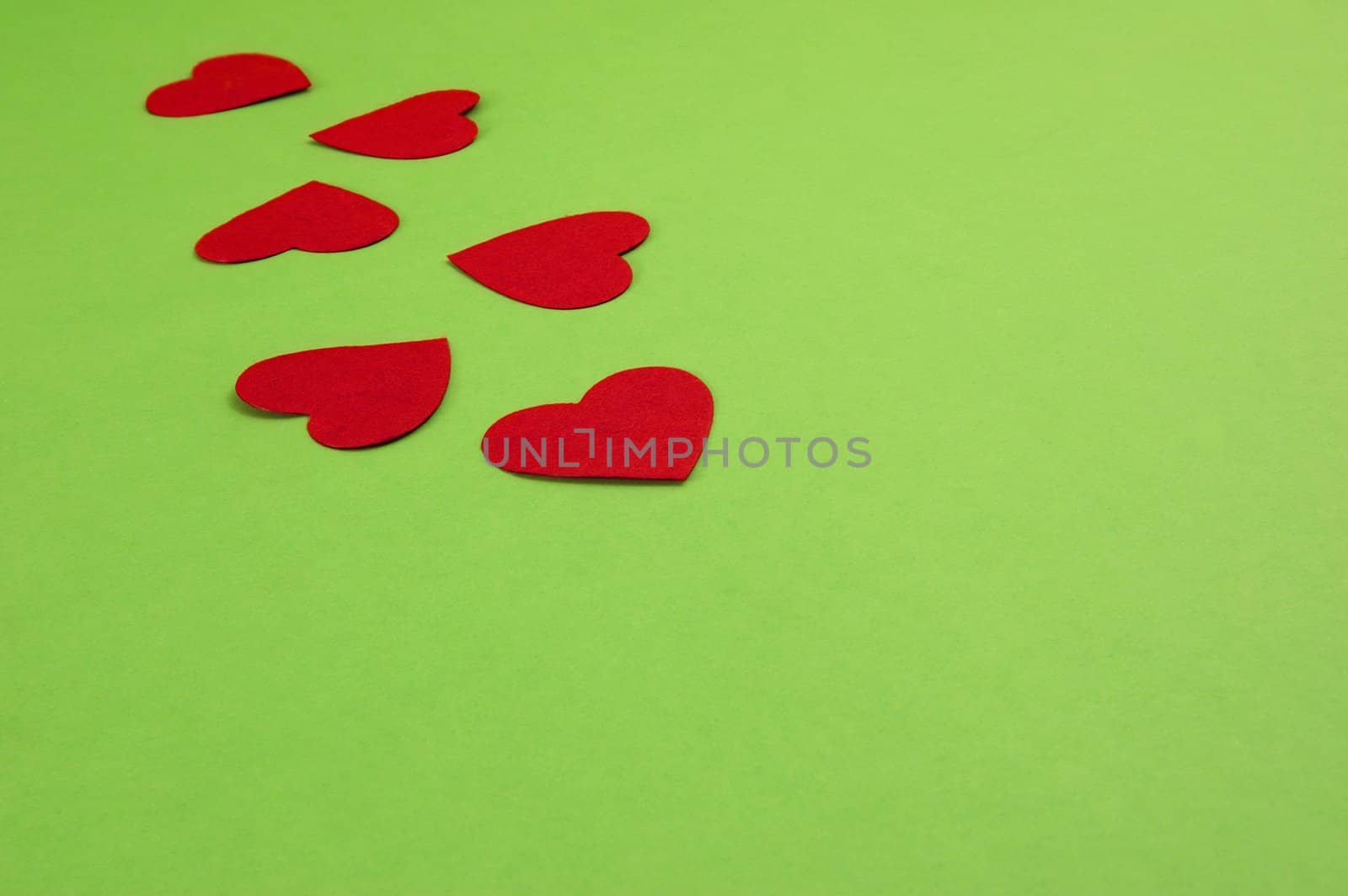 green background with red paper hearts