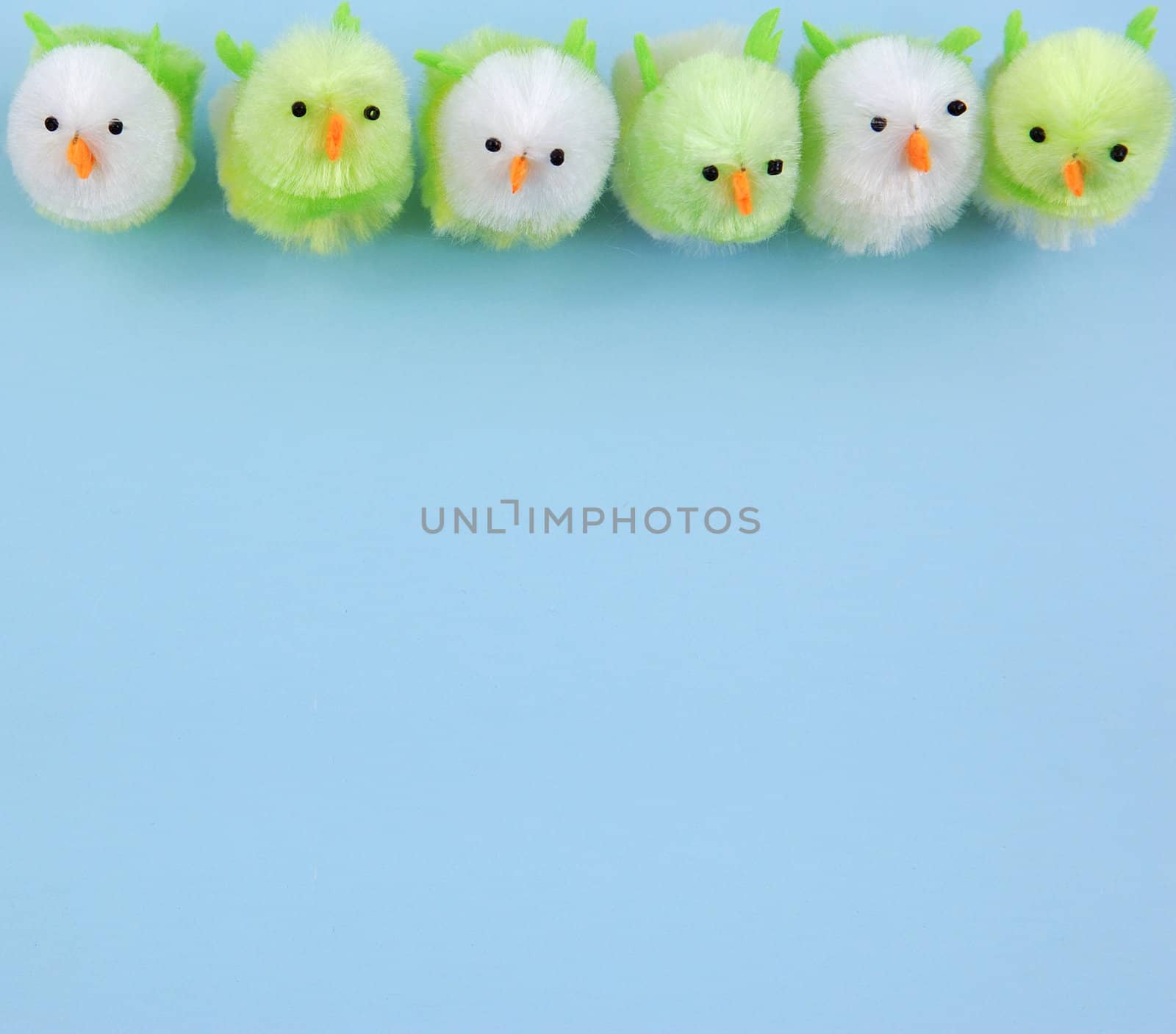 row of easter chicks on blue background by maggiemolloy