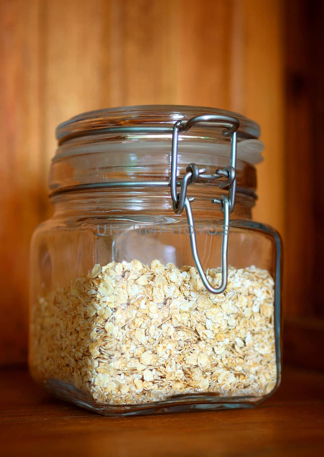 Glass jar of porridge oatmeal by maggiemolloy