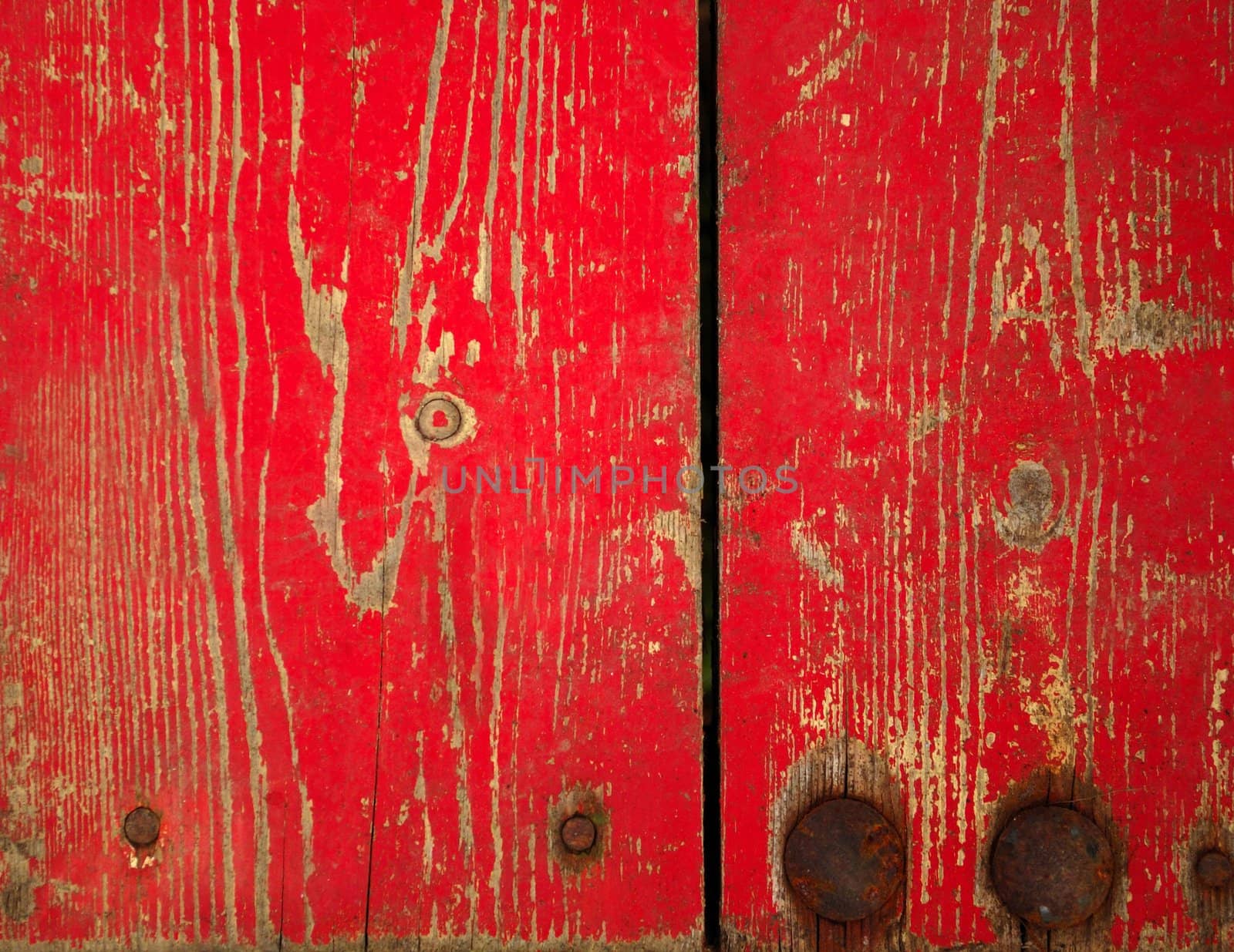Wood with chipped red paint. Grunge style background
