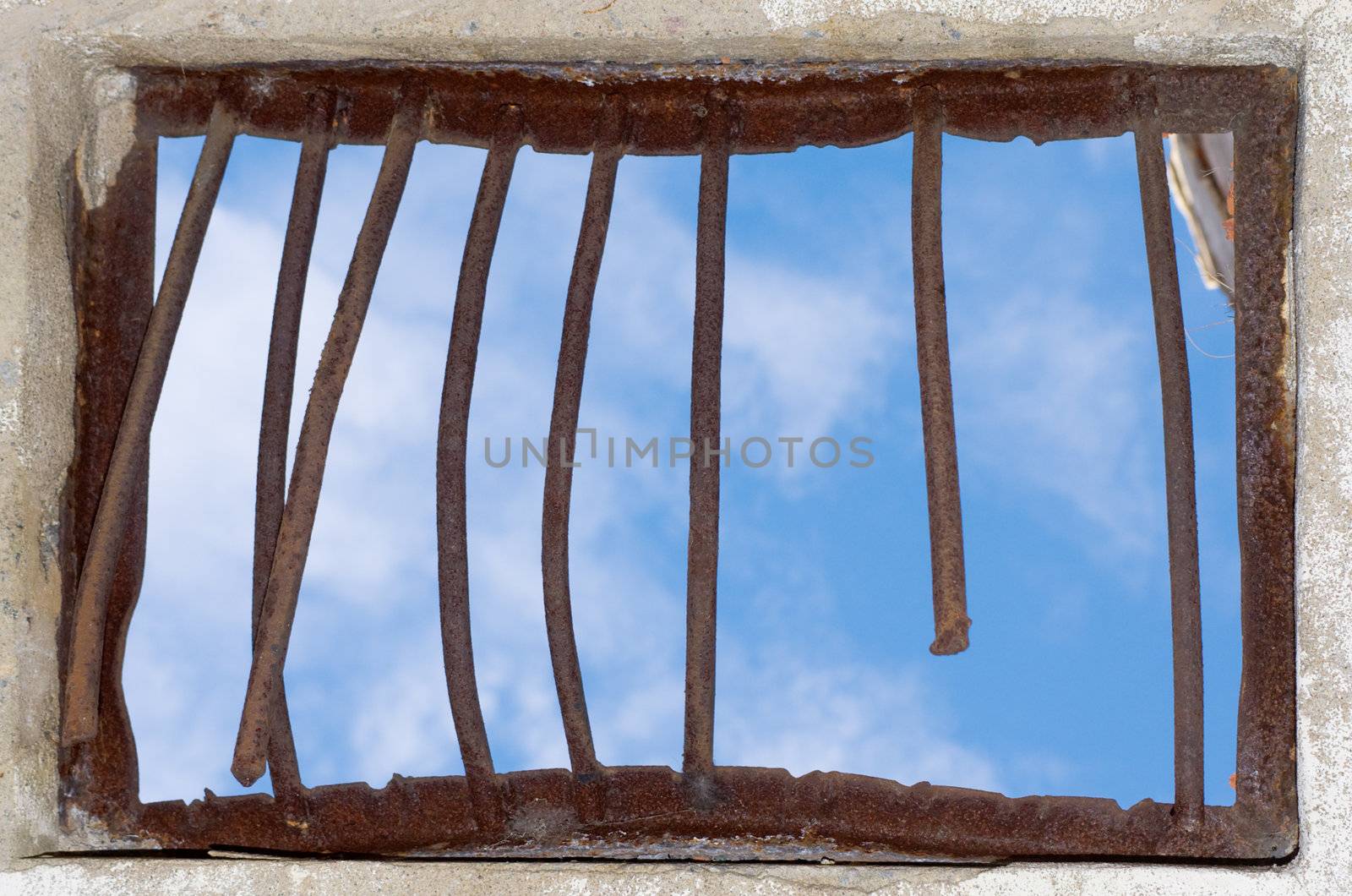 Old window closed by a rusty lattice