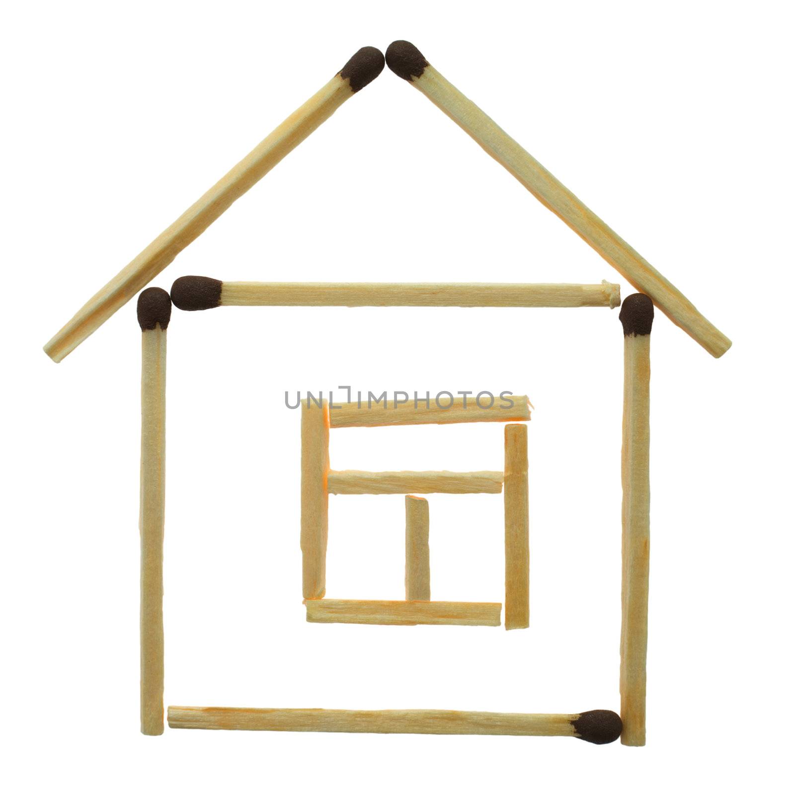 Small house from matches on a white background