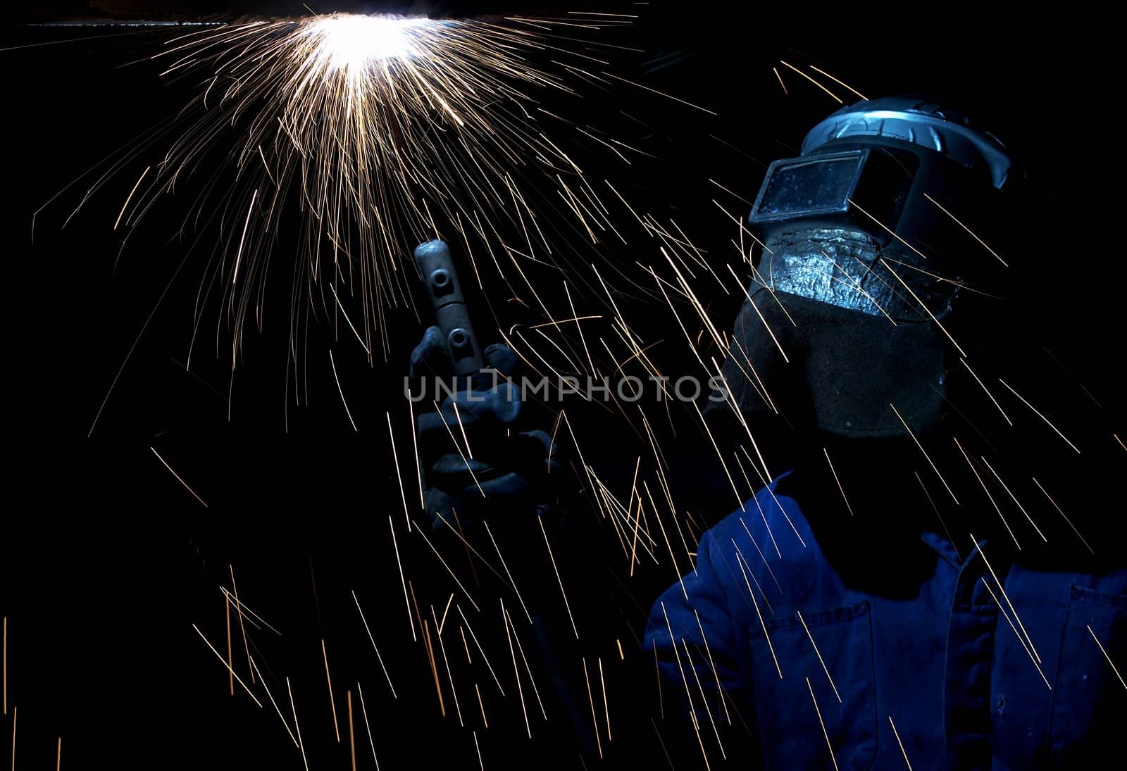 a welder working at shipyard at night