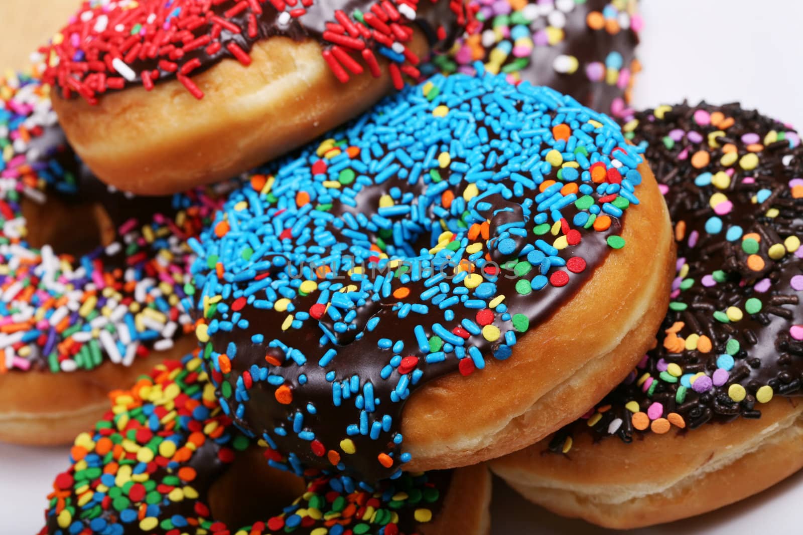 Colorful donuts on plate by jarenwicklund