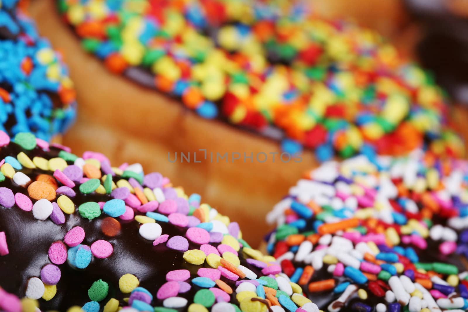 Colorful donuts on plate