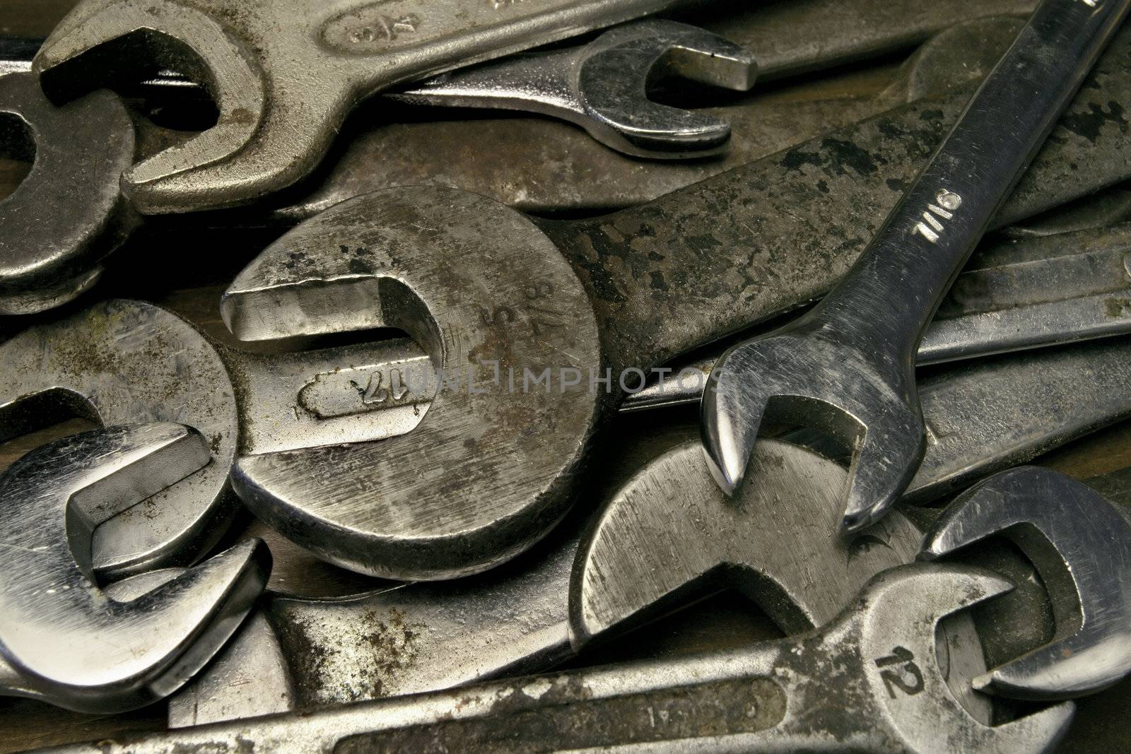 Pile of old used and dirty wrenches.
