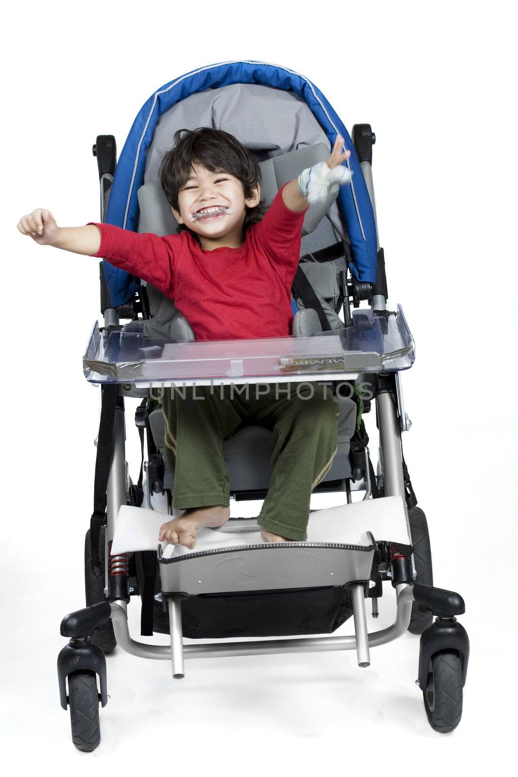 Three year old disabled boy in medical stroller