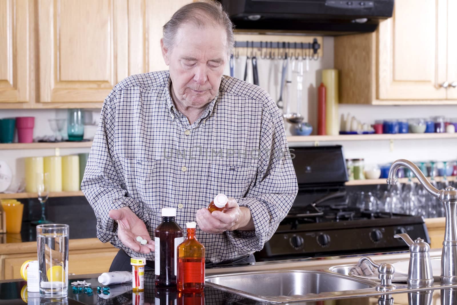 Elderly man preparing to take medicine