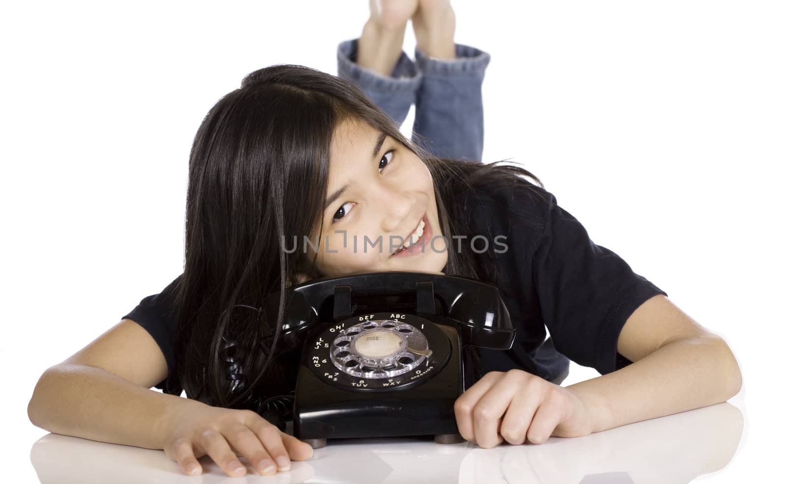 Young girl lying by old phone