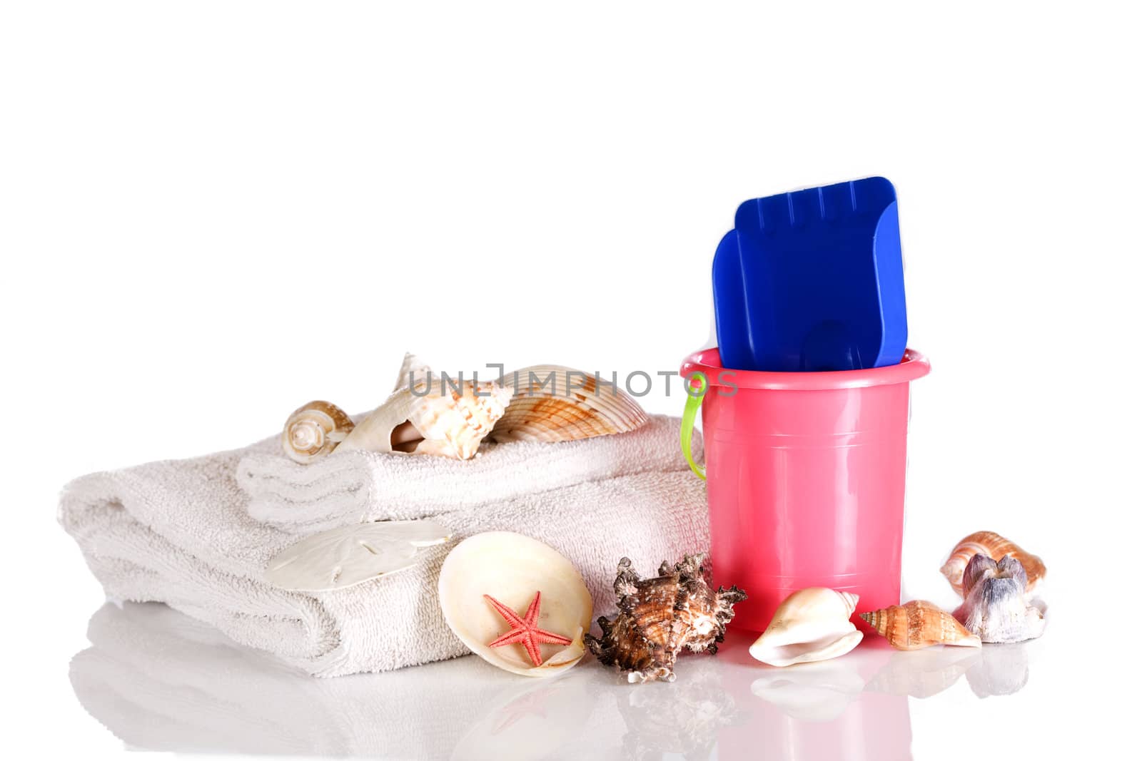 Shells, towels and bucket ready for the beach by jarenwicklund