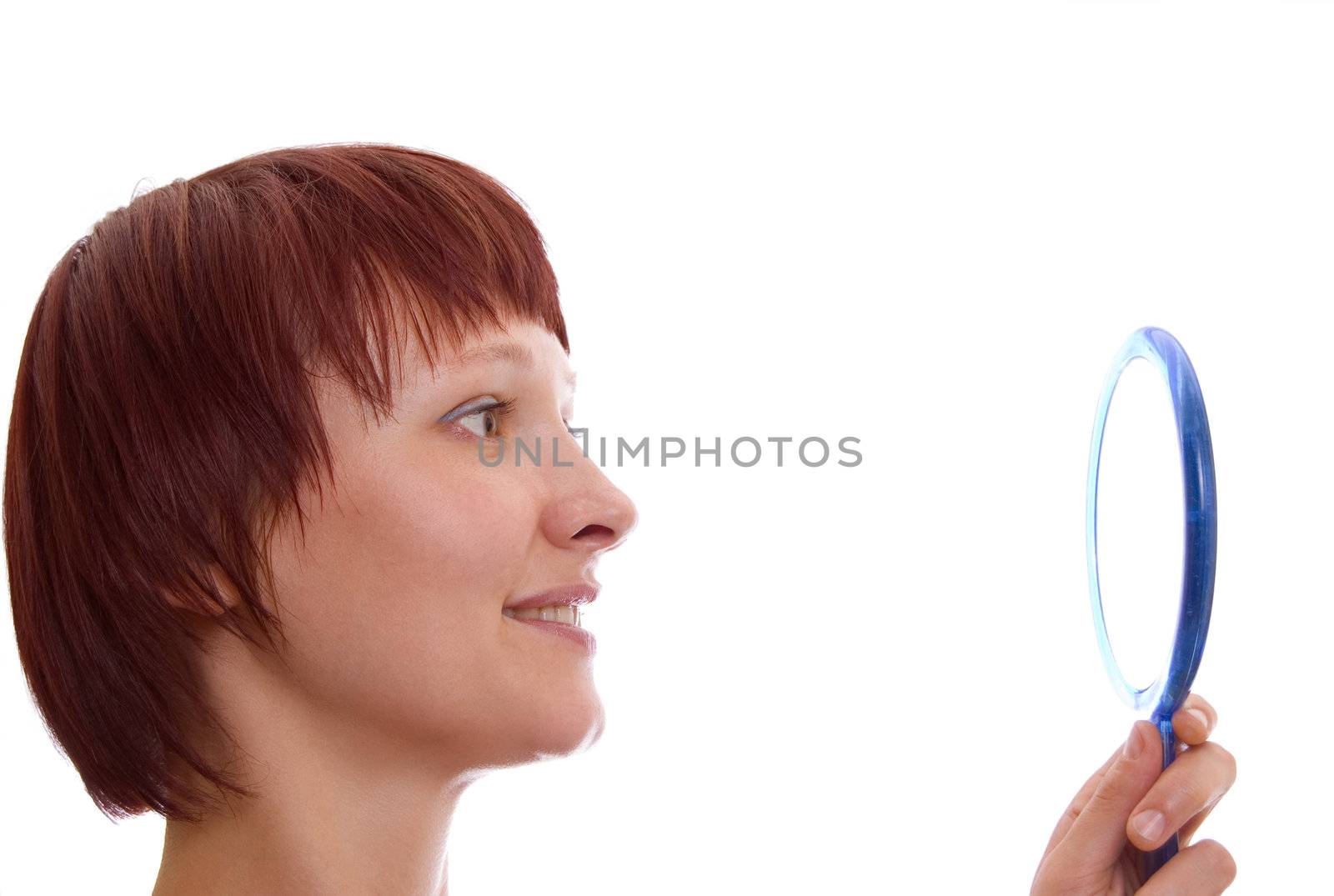 Portrait of red-haired girl with a mirror in a high key.