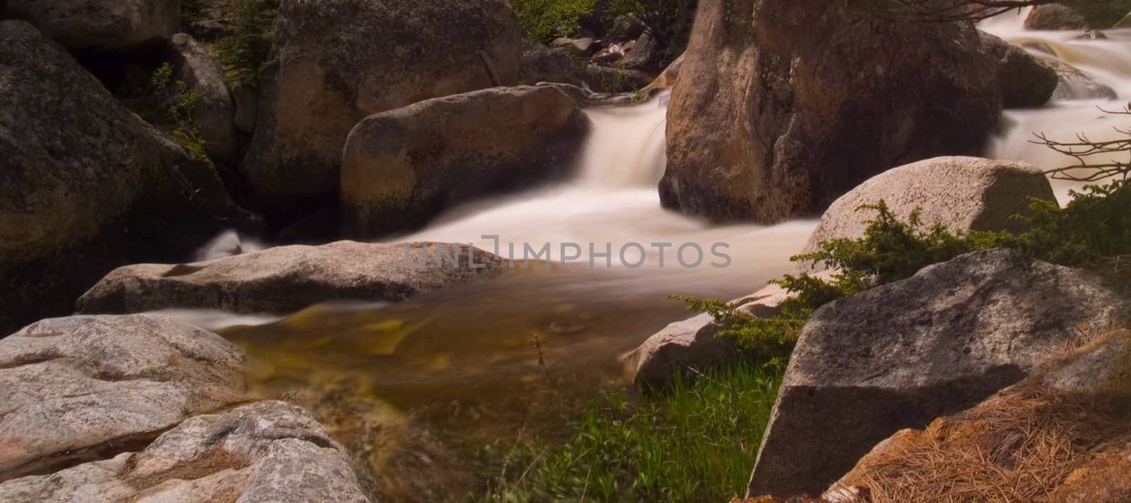 A bend in a rocky mountain river rushing with spring runoff.