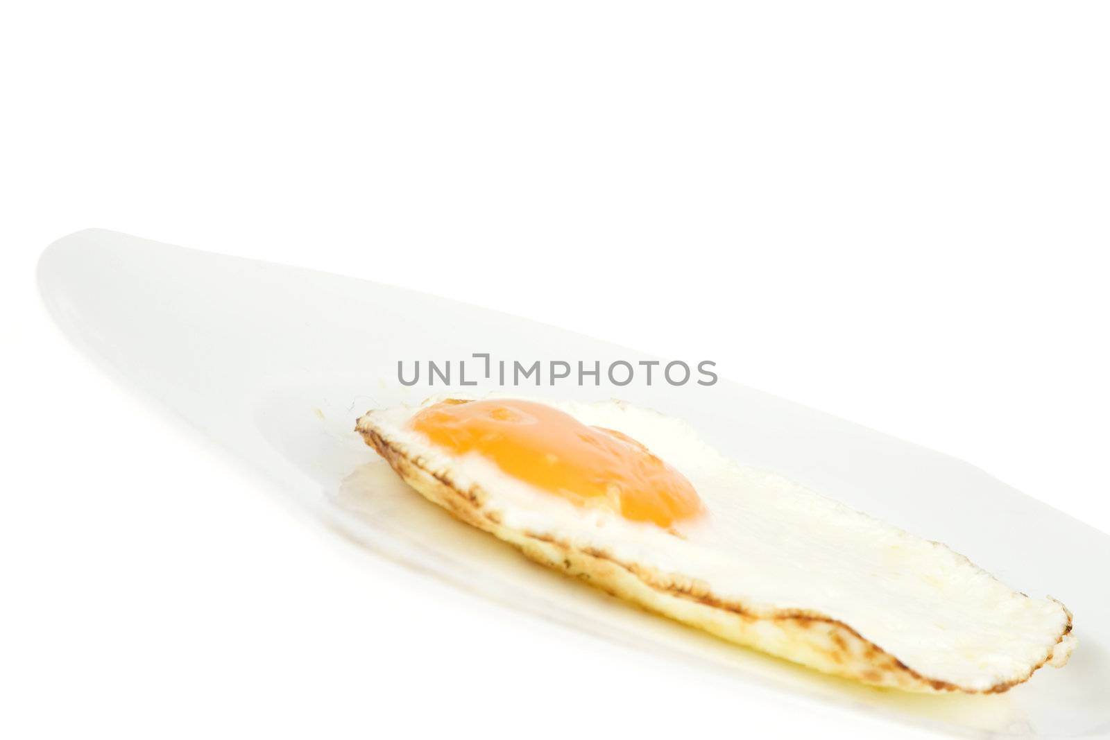 a fried egg on a white plate