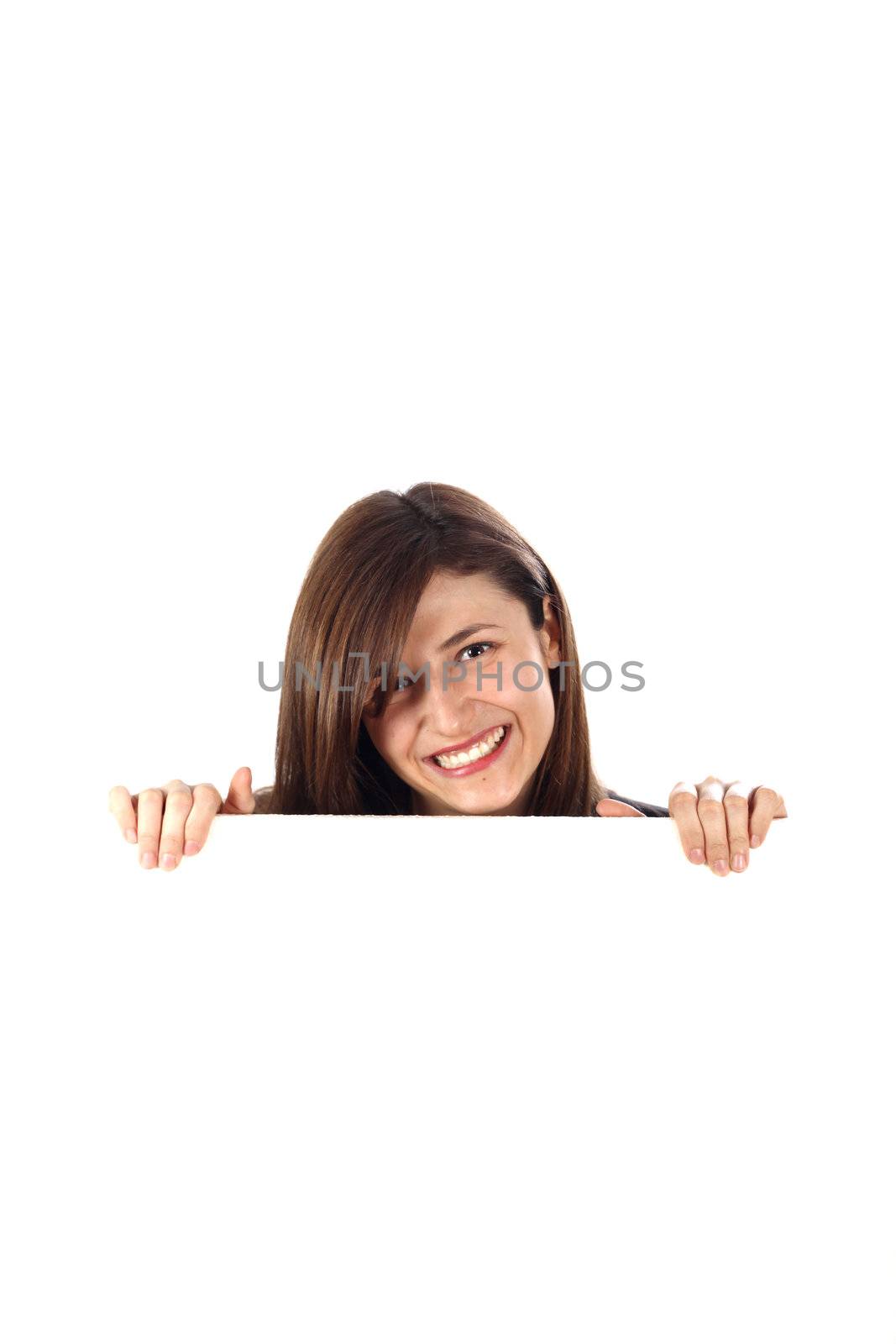 Cheerful woman looks out from behind an unmarked plate. The background is white and provides space for text.