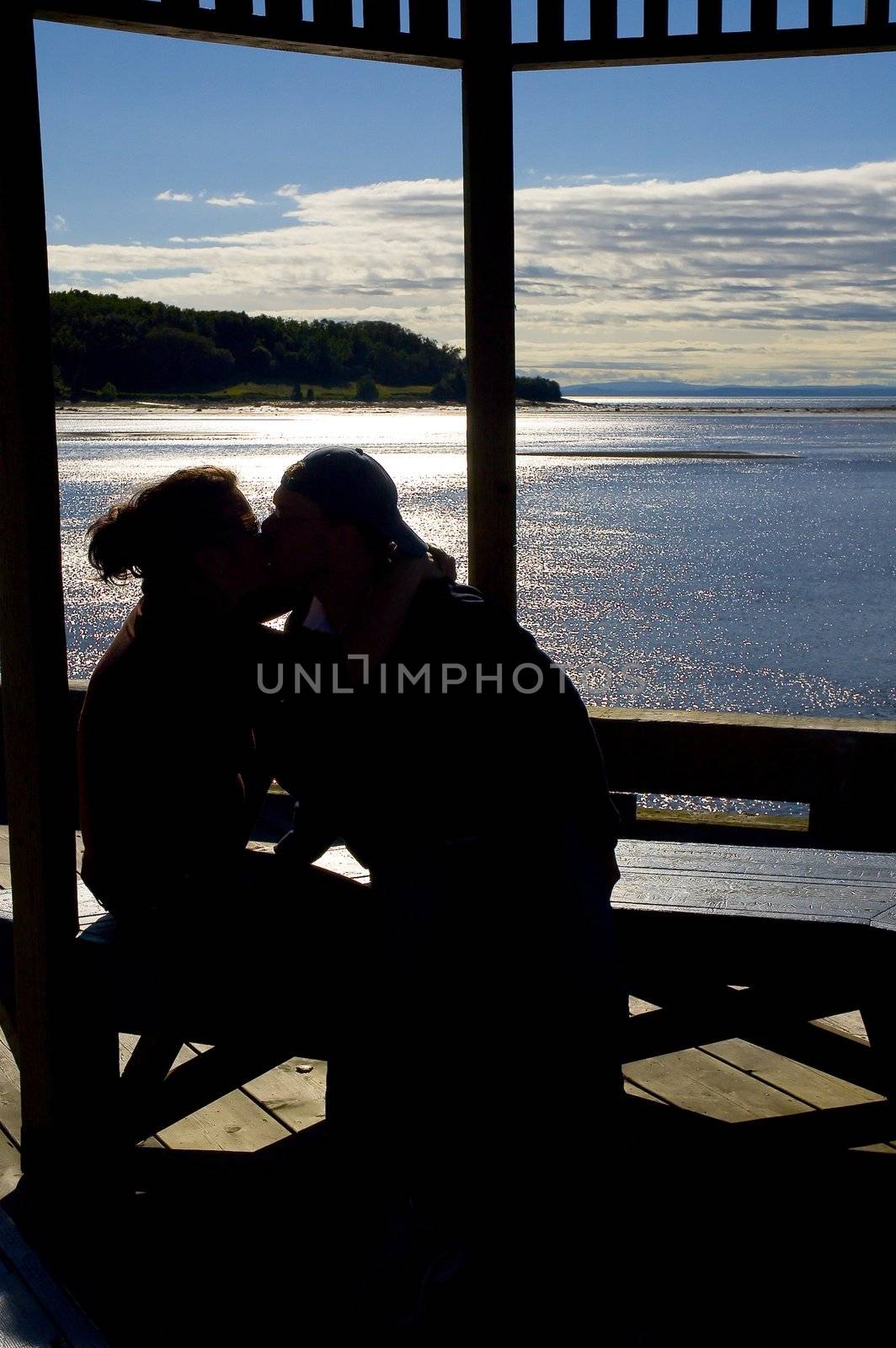 happy couple kissing by the ocean view