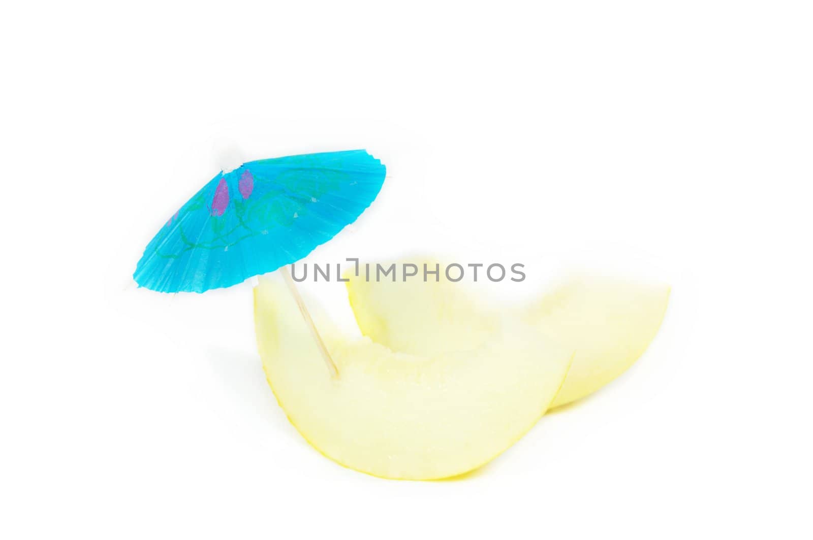 two melon slices with umbrella isolated on white
