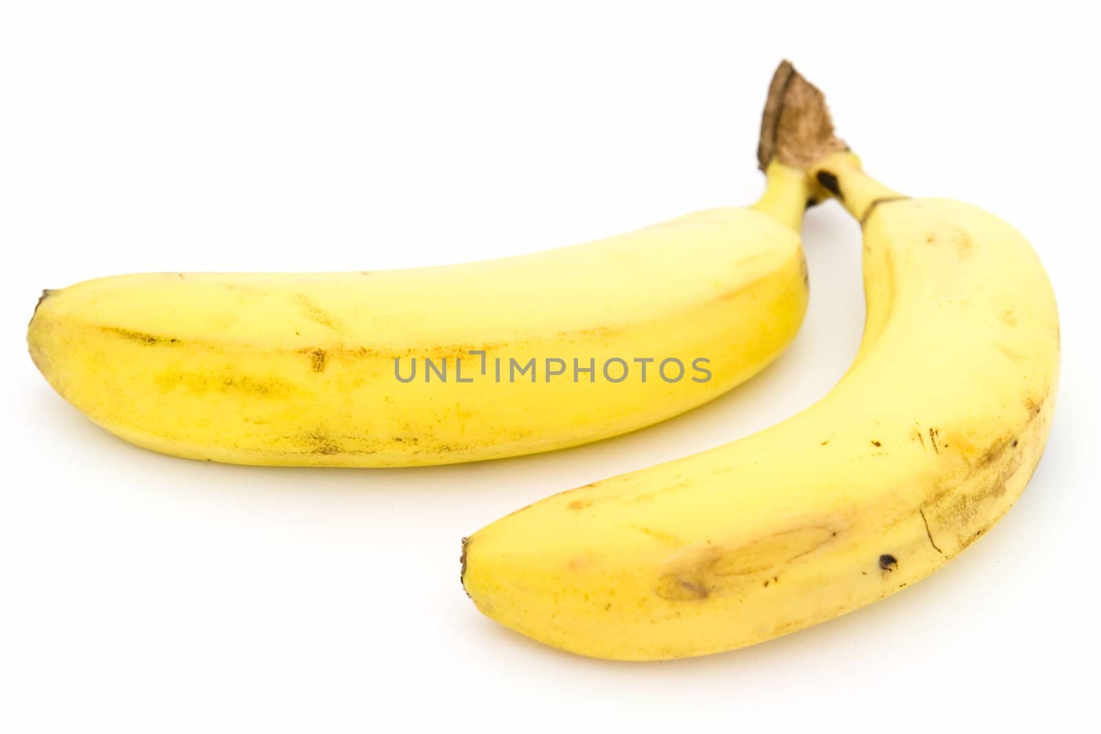 Two yellow bananas on a white background