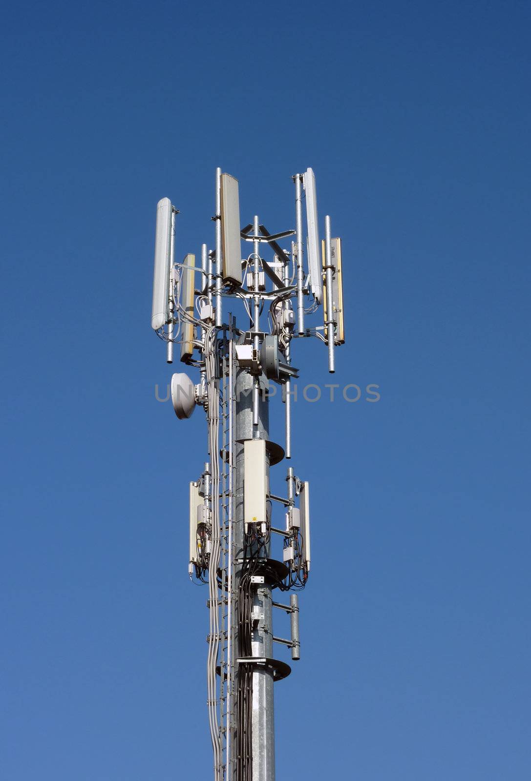 Closeup of communication tower against blue sky