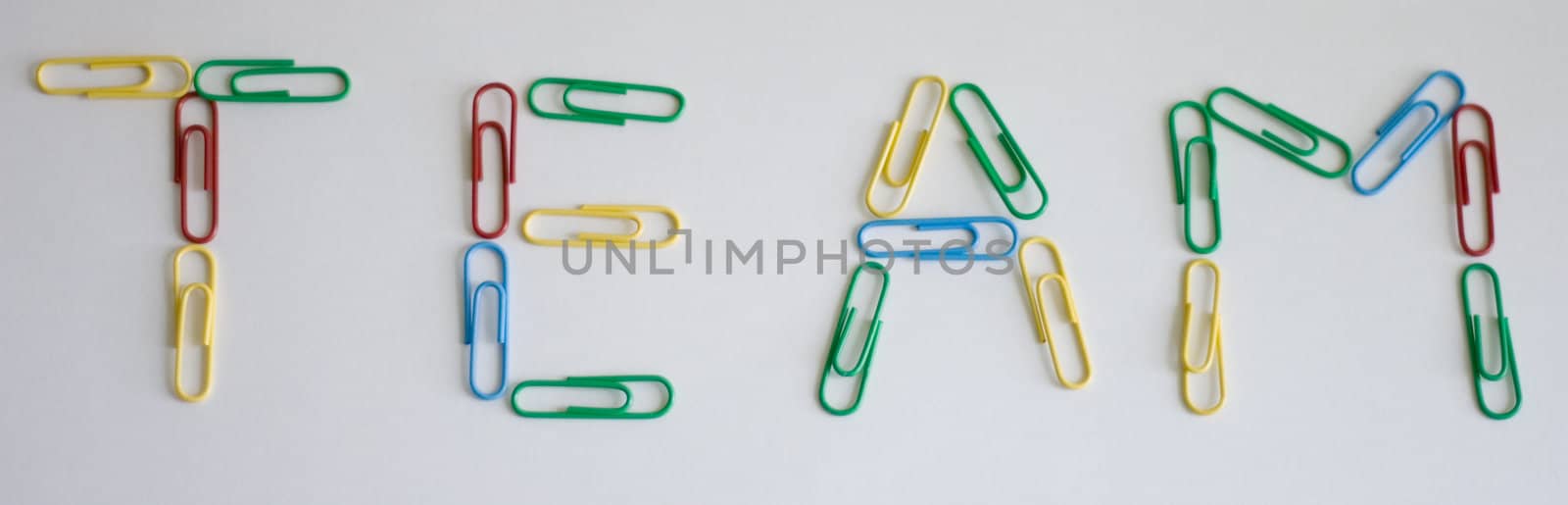 multi-color paper-clips on grey background