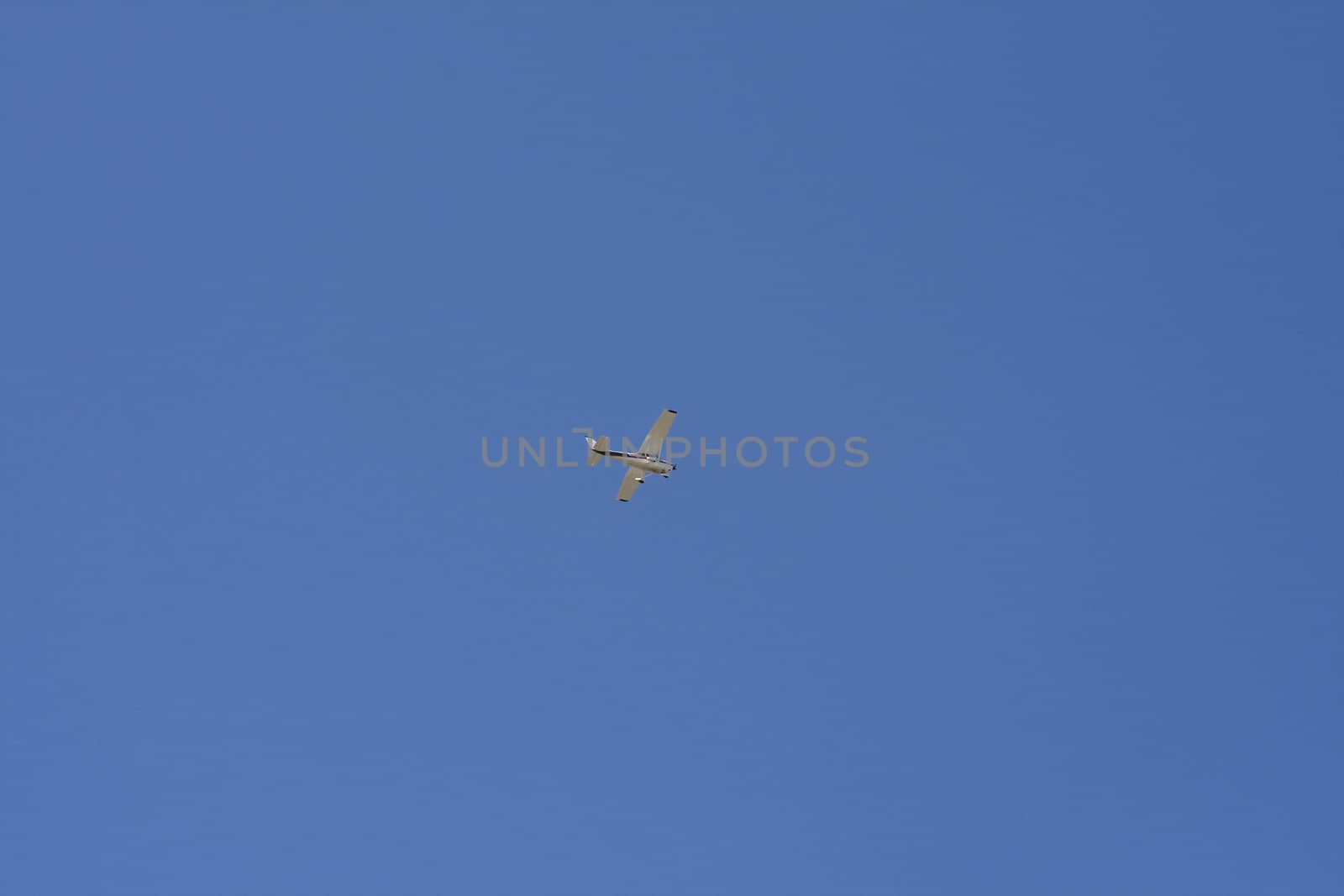 Airplane in the blue sky by ursolv
