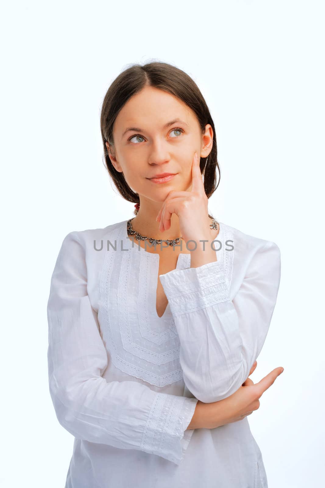 Beautiful young woman looking away over white background 