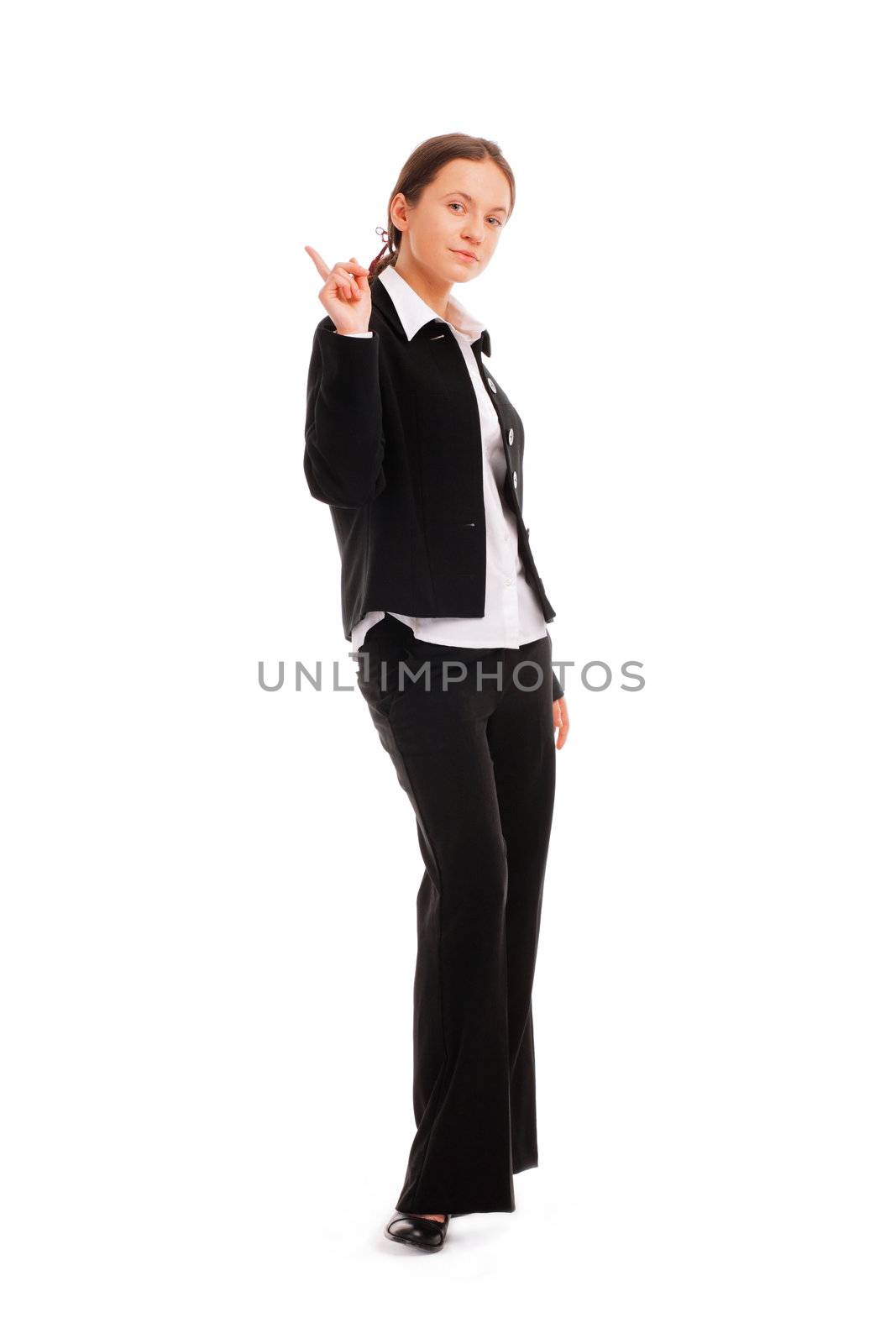 Full length of a smiling young business woman pointing up at copyspace 