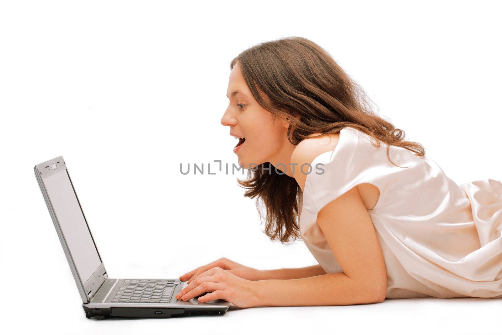 Profile view of a happy young female using a laptop over white background