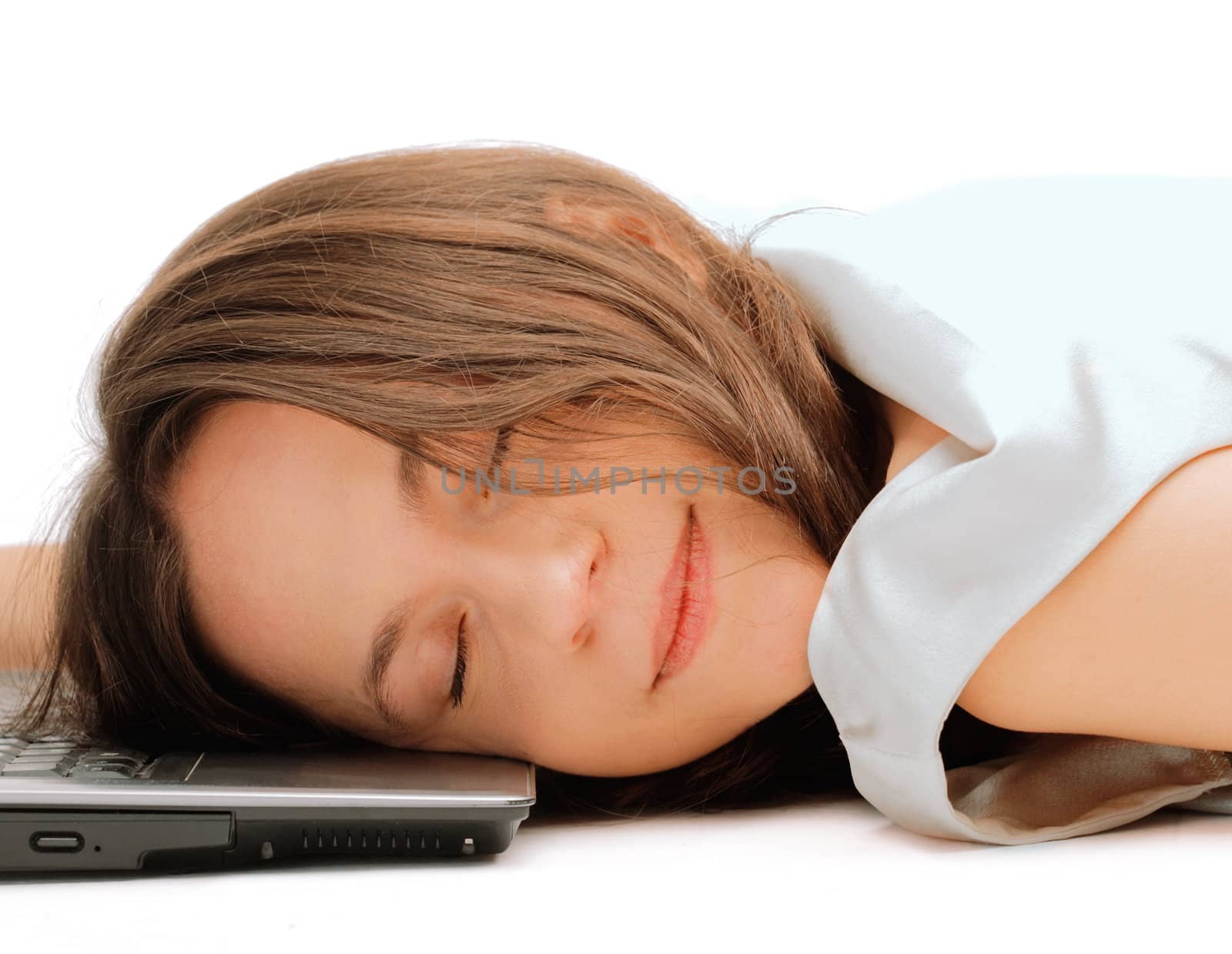 Closeup of a young woman sleeping on the laptop