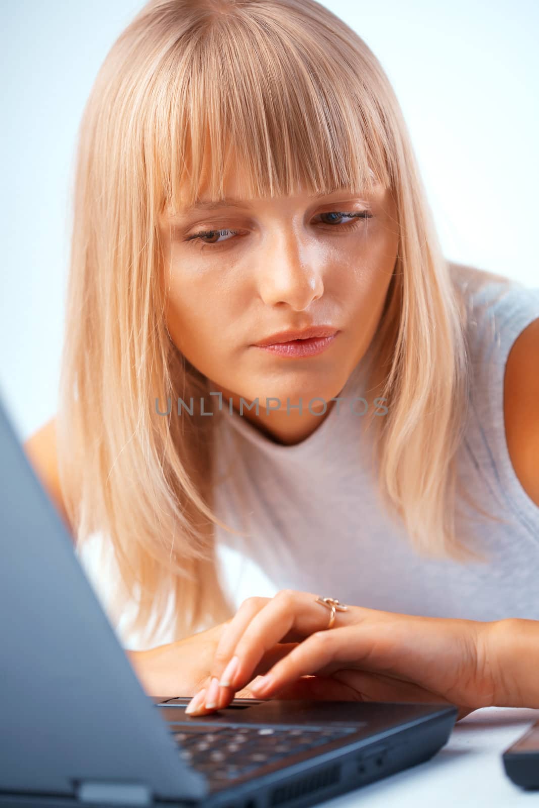 Beautiful woman working with laptop by romanshyshak