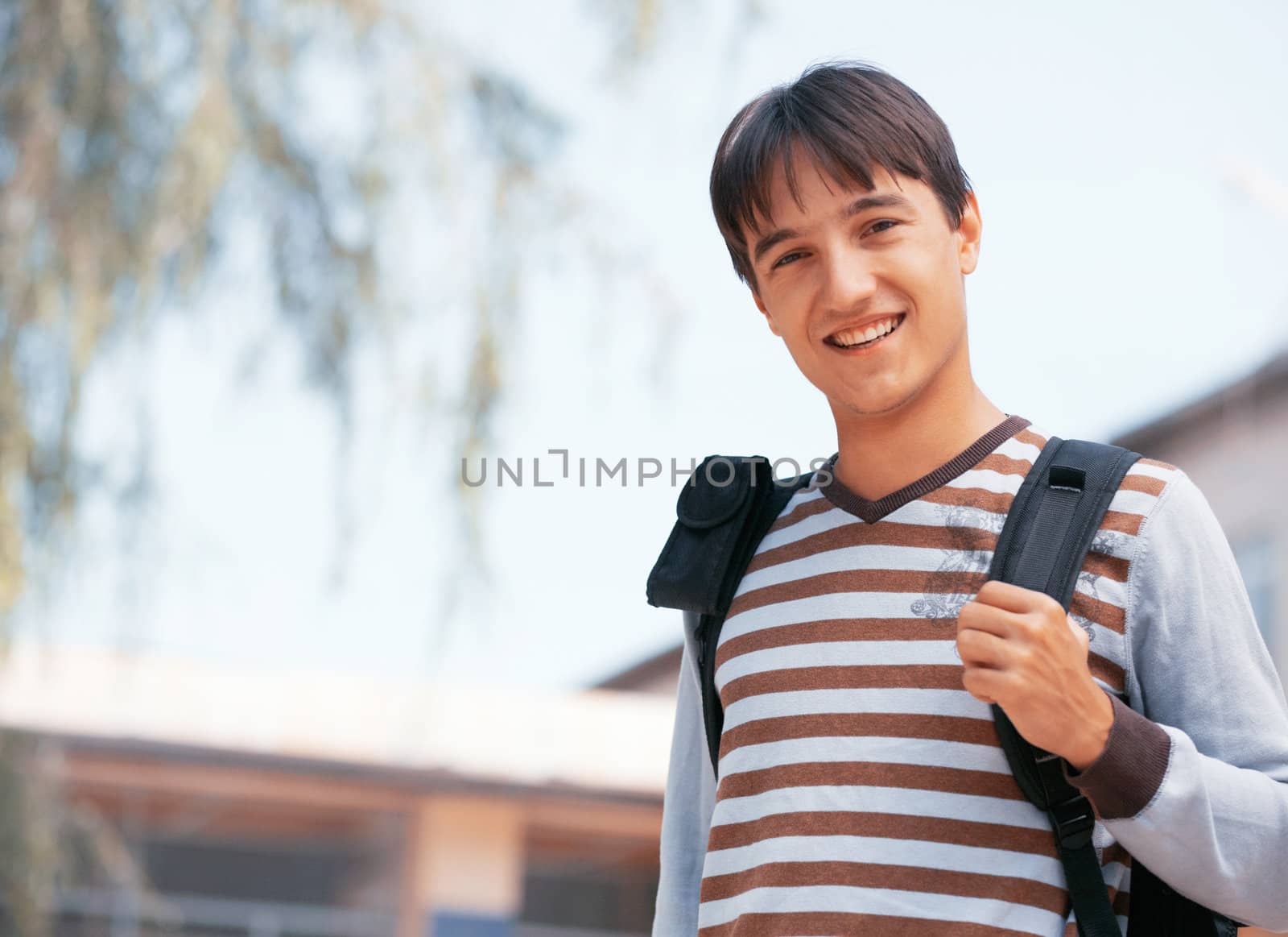 Young man with bag in the town