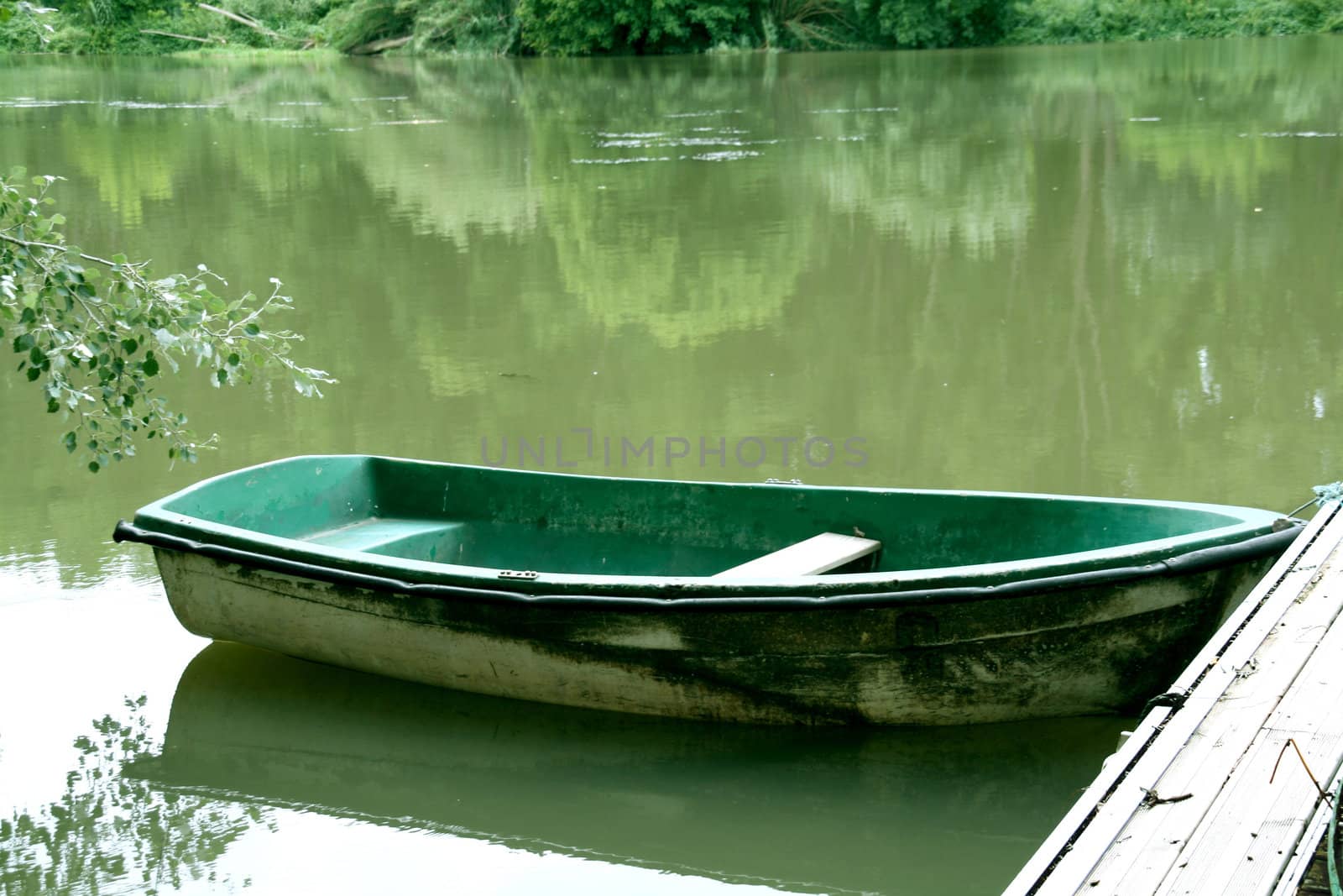 abandoned green boat at the river, peacefull landscape.