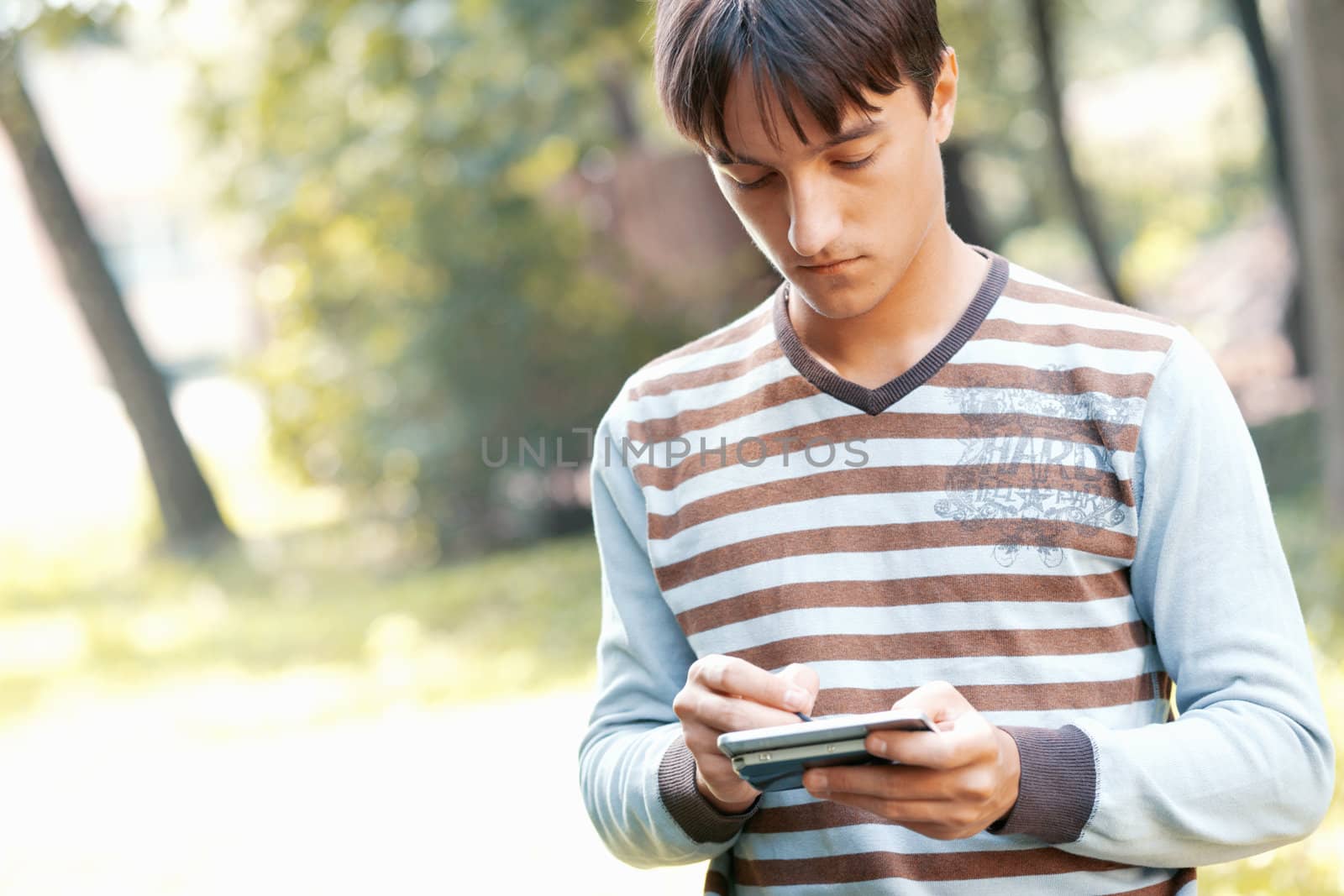 Young man with his pocket computer by romanshyshak