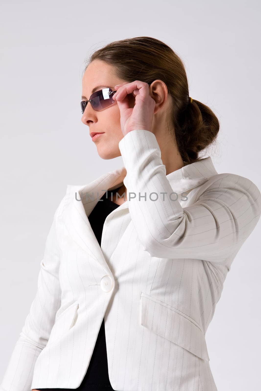 Young sturdy woman with sunglasses on a white background