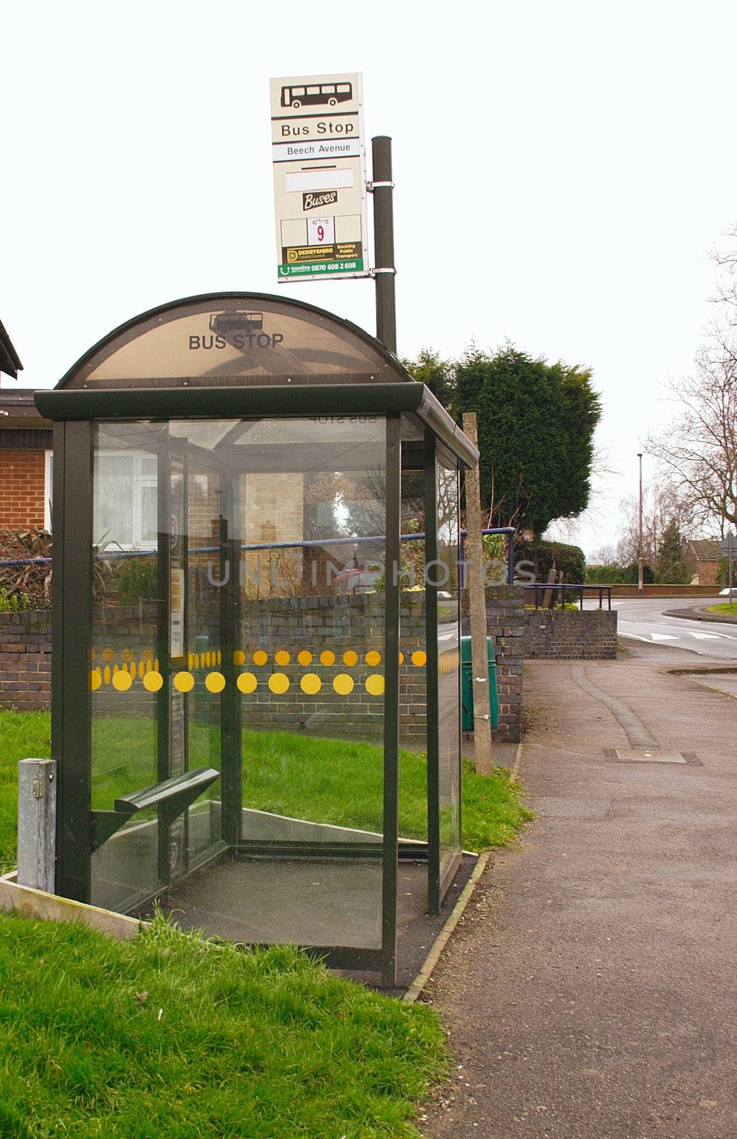 glass covered bus stop situated on a bus route