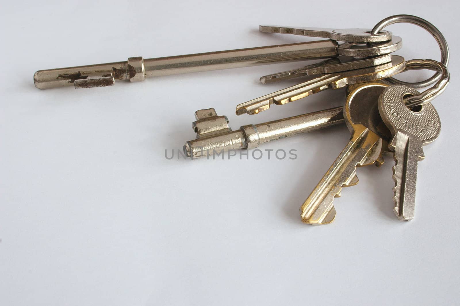 large bunch of housekeys over a light background