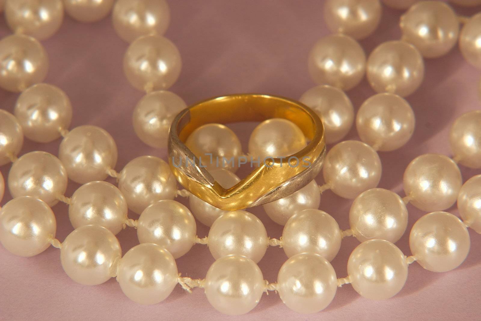 wedding ring and a string of pearls for the bride