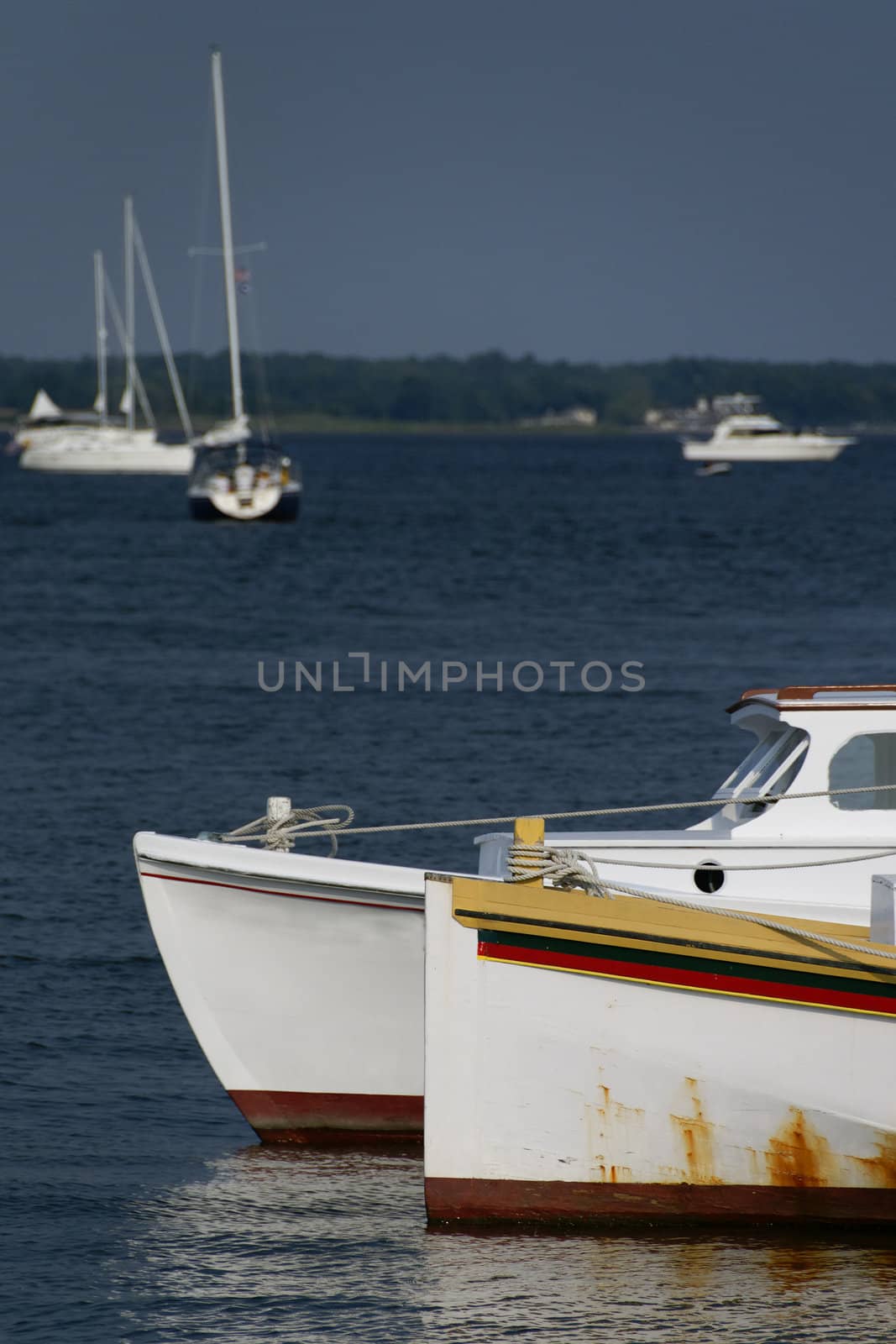 Motorboats and sailboats at anchor.