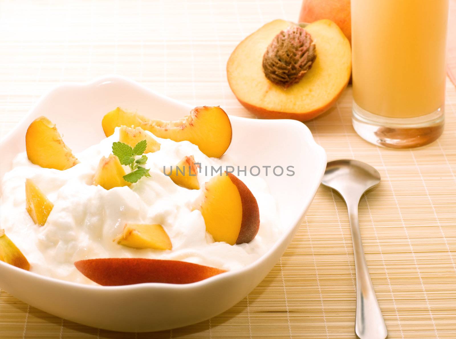 Yogurt with fresh peaches and mint for healthy breakfast. Light toning.