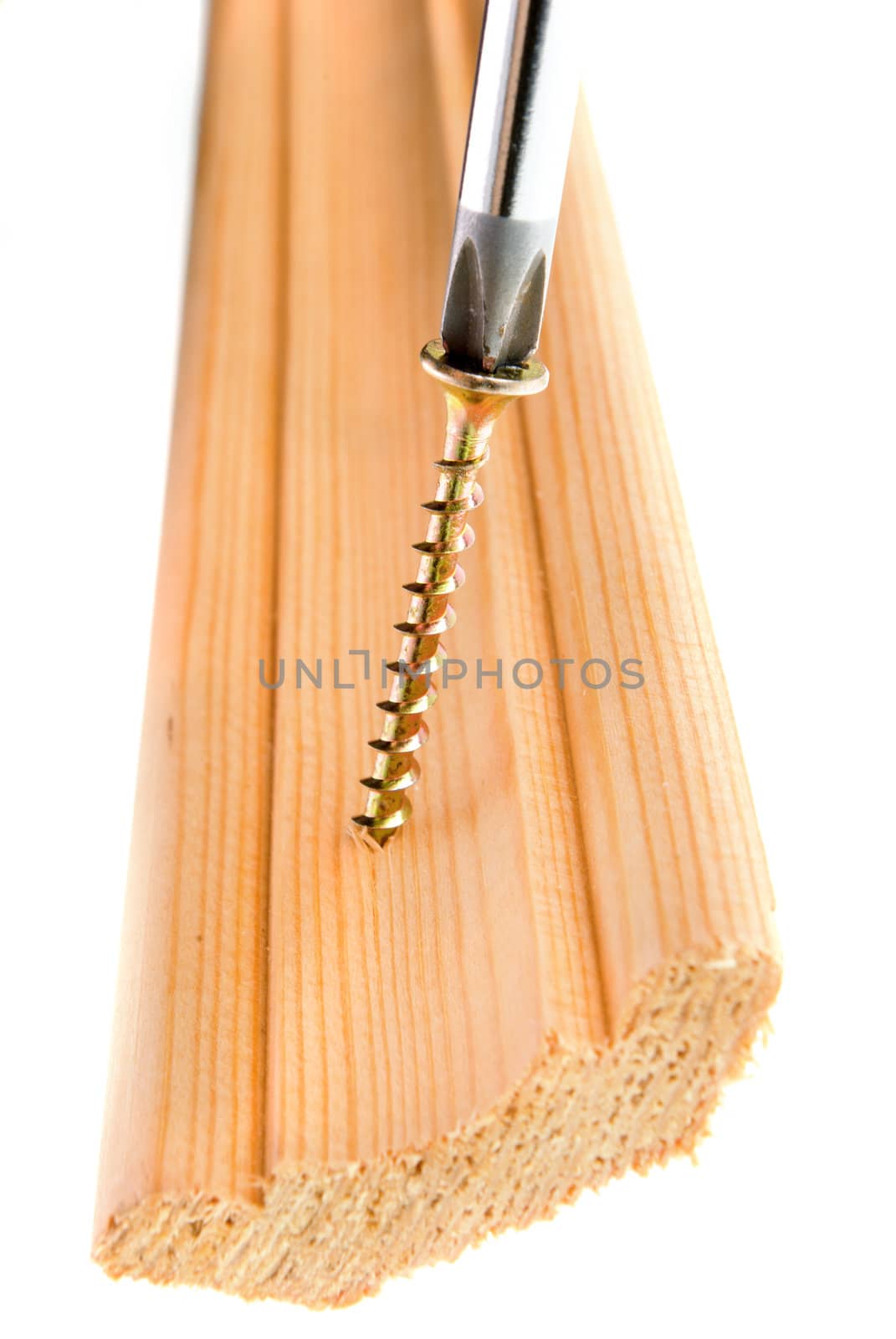 Screwdriver and single screw in board.a,isolated on white background. wooden plinth